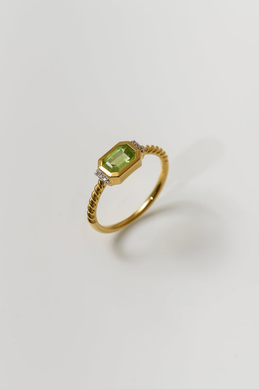 Gold Solae Ring with green peridot center stone and white topaz accents