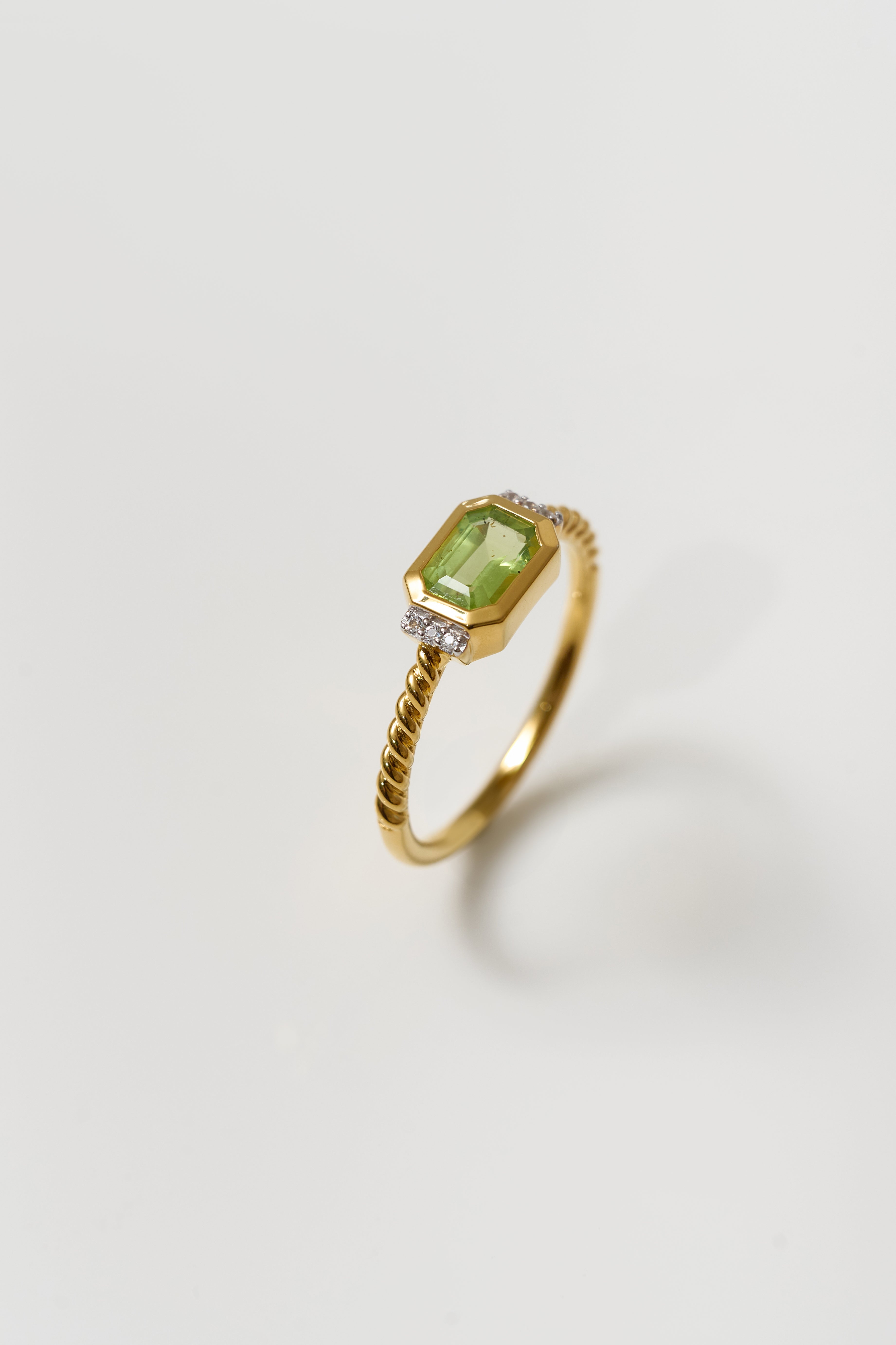 Solae Ring with green peridot and white topaz on twisted gold band