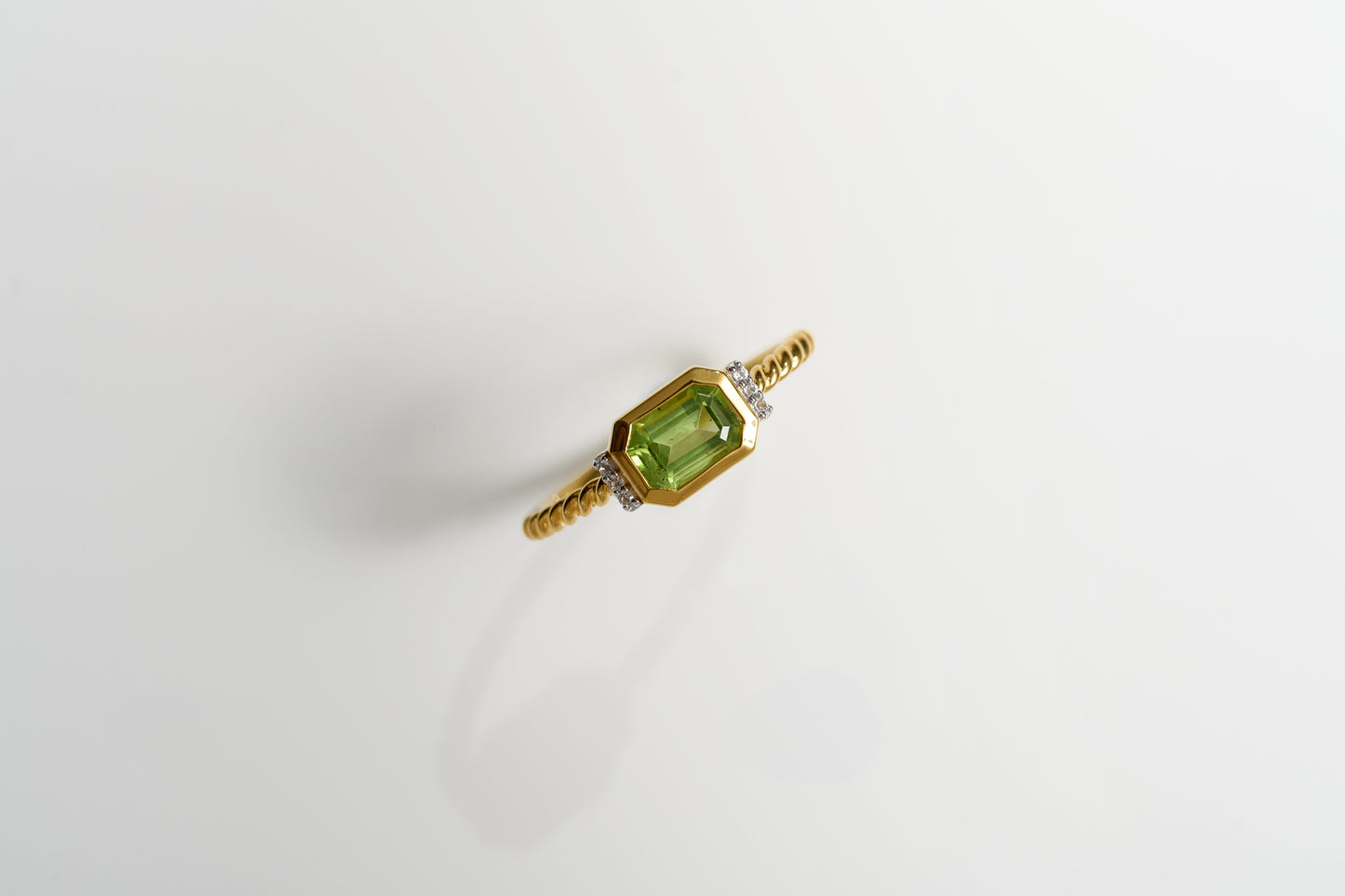 Solae Ring with green peridot and six white topaz accents on gold band