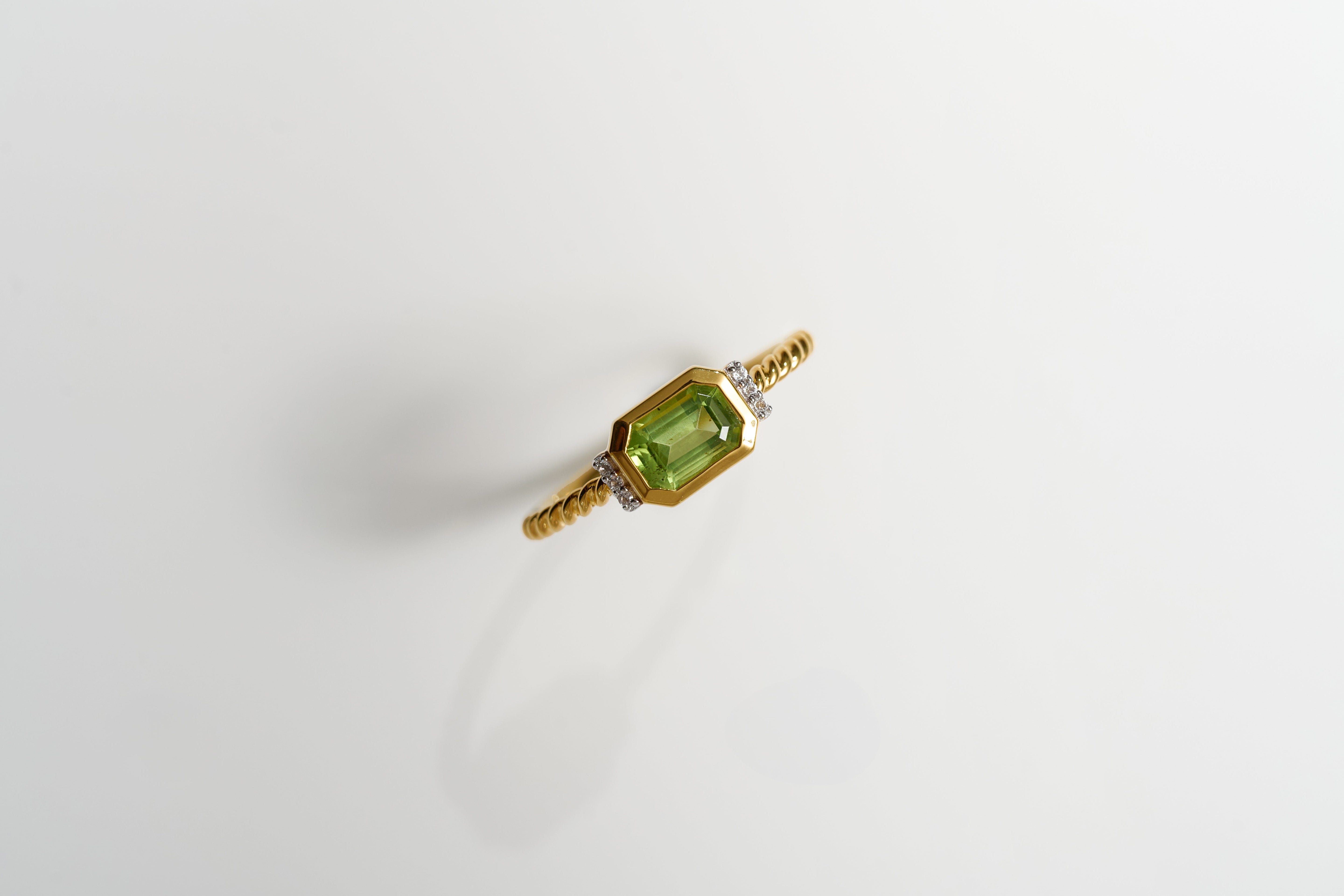 Solae Ring with green peridot and six white topaz accents on gold band