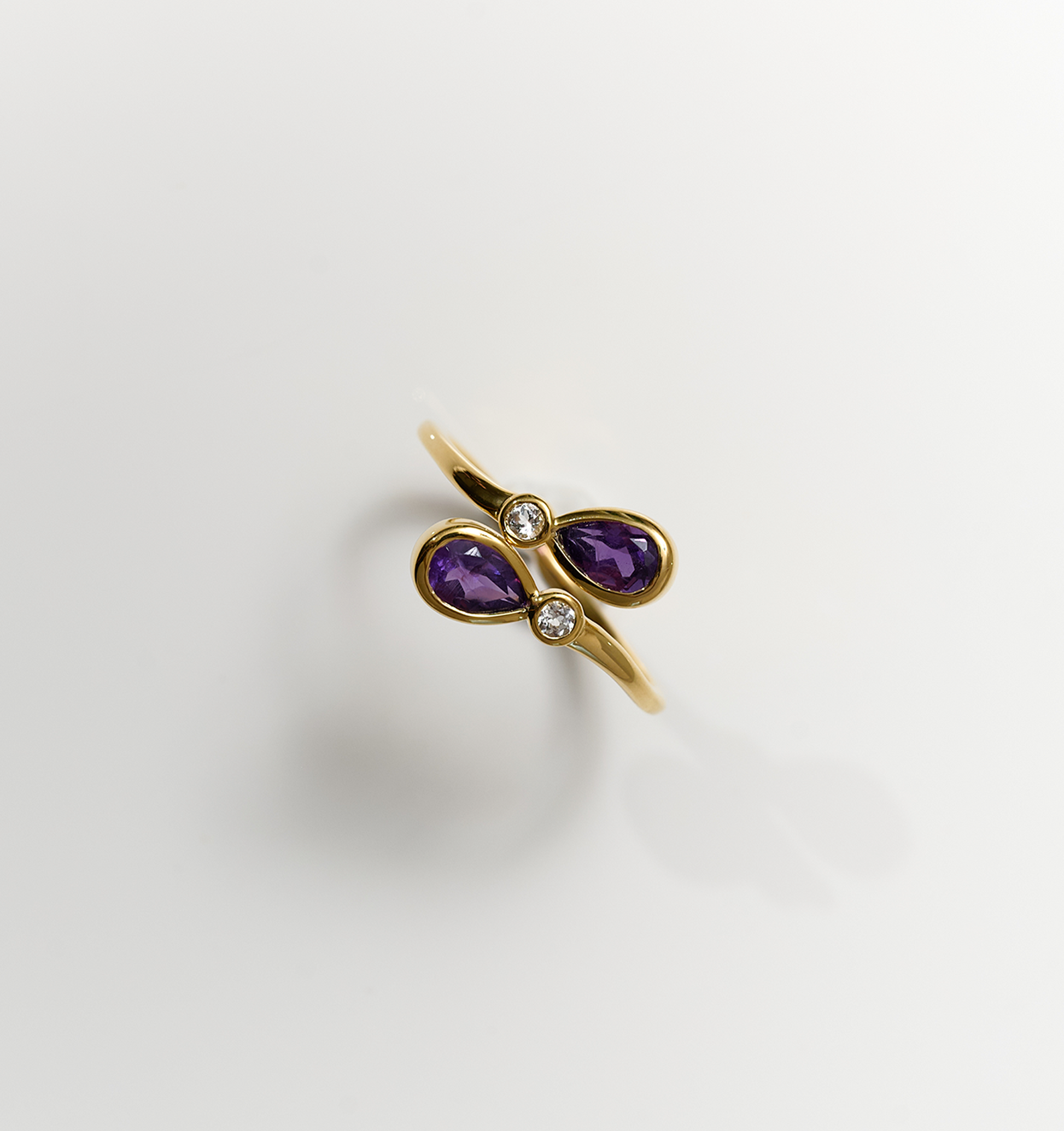Nimira Ring with twin amethysts and two white topaz set in gold band