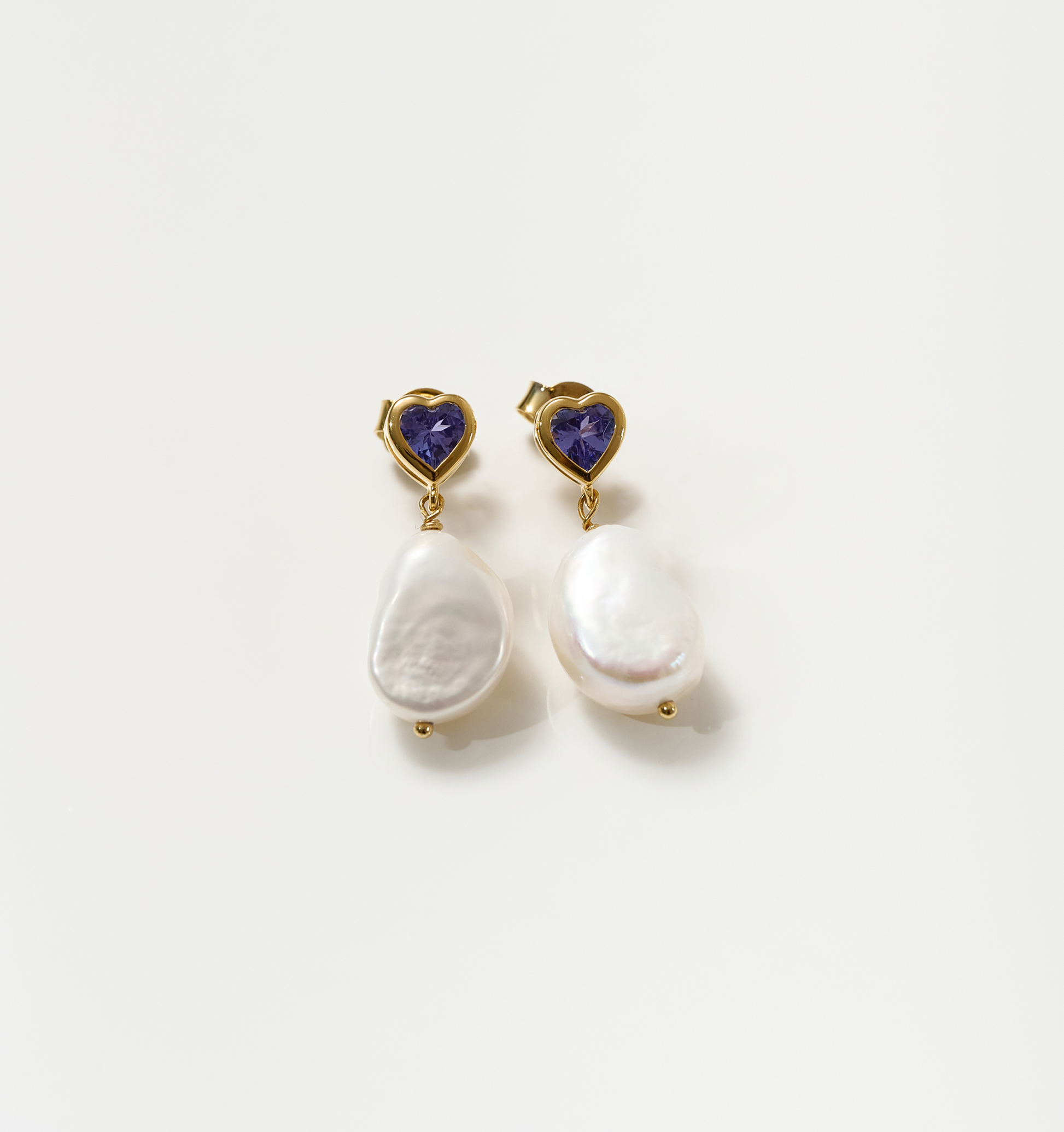 Hridaya Earrings with heart-shaped tanzanite and irregular pearl drops in gold setting