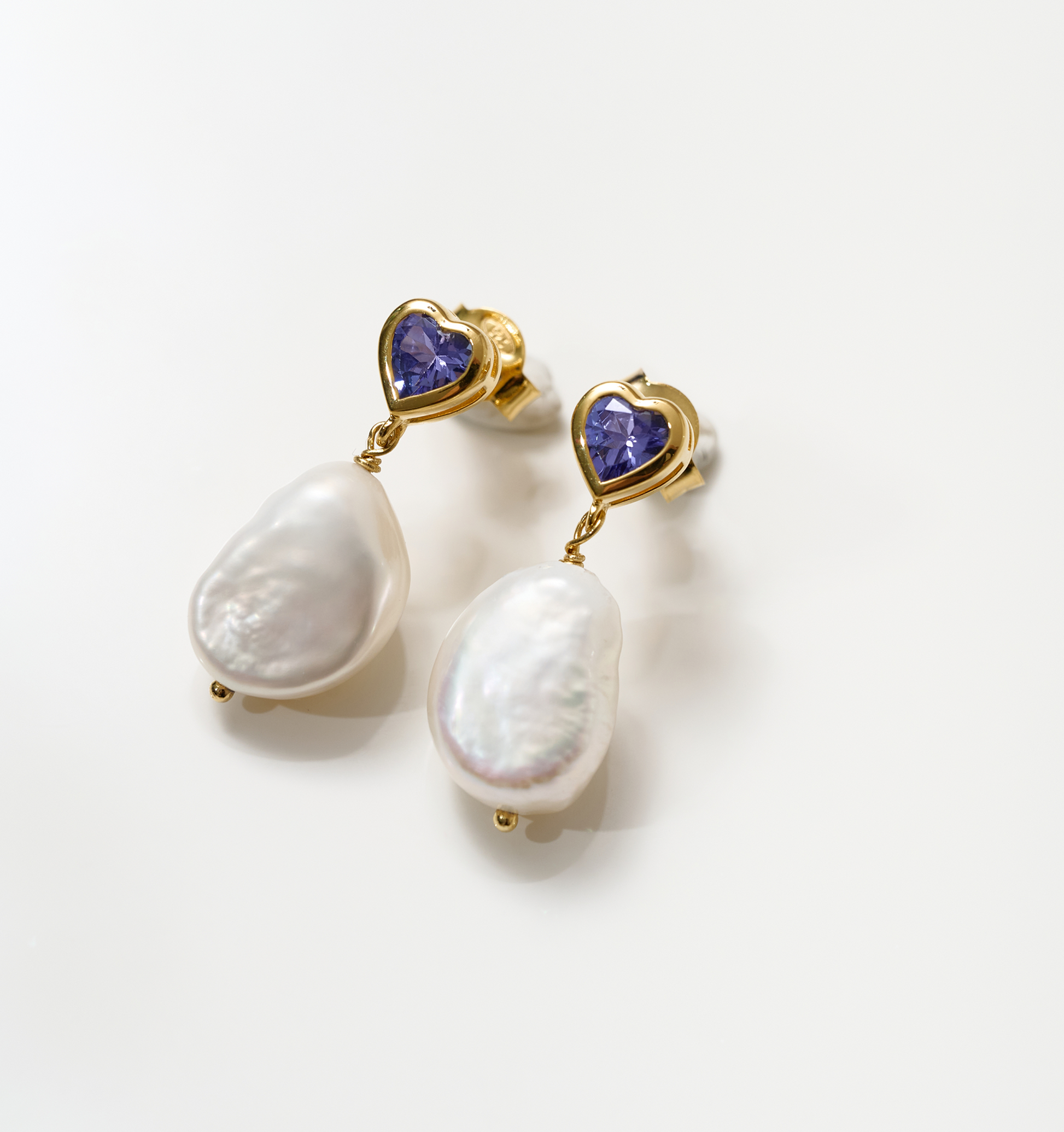 Hridaya Earrings with heart-shaped tanzanite and dangling white pearls in gold setting