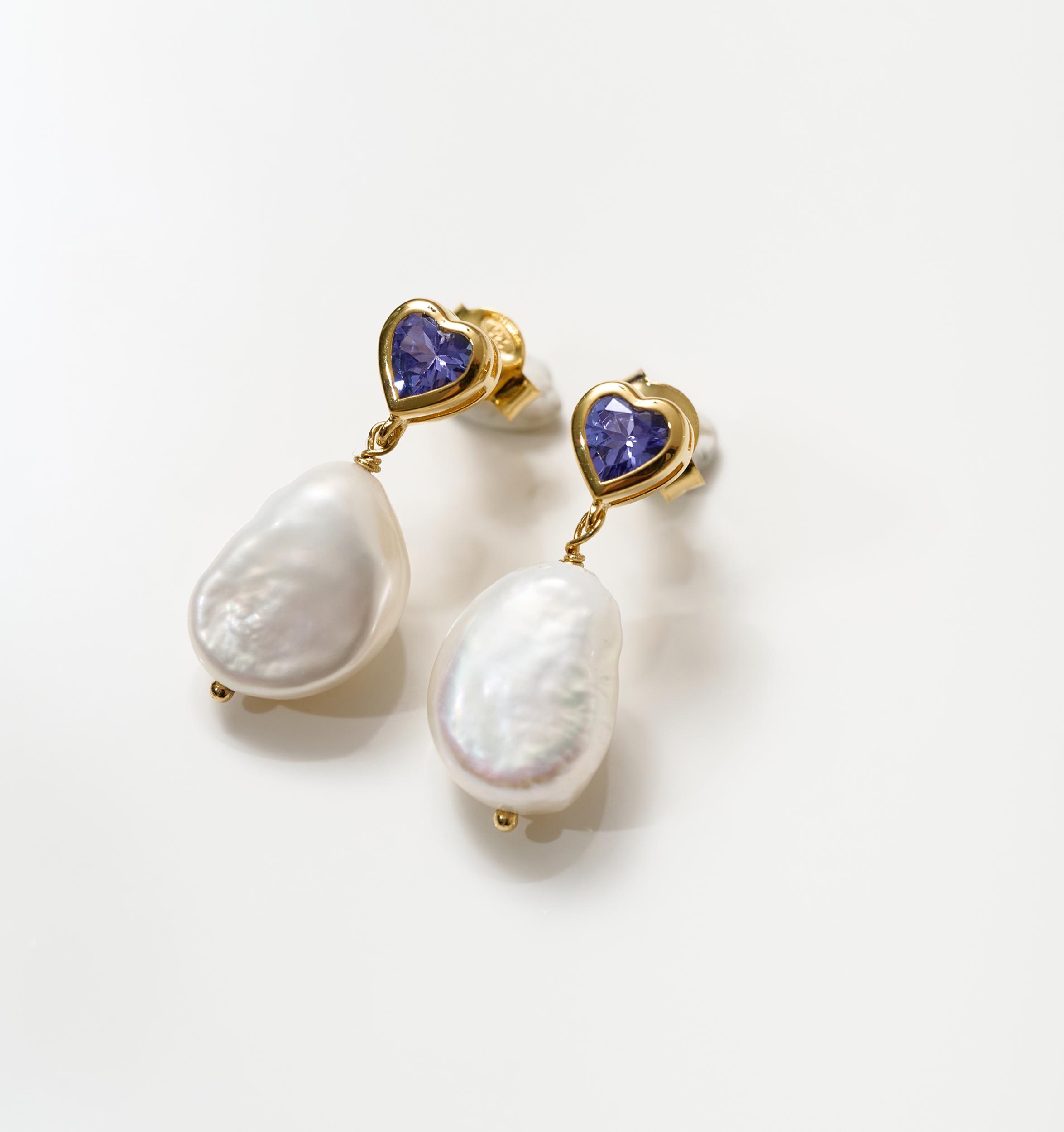 Hridaya Earrings with heart-shaped tanzanite and dangling white pearls in gold setting