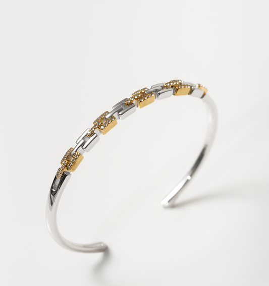 Noura Cuff gold and silver bracelet with 52 sparkling stones on a white background