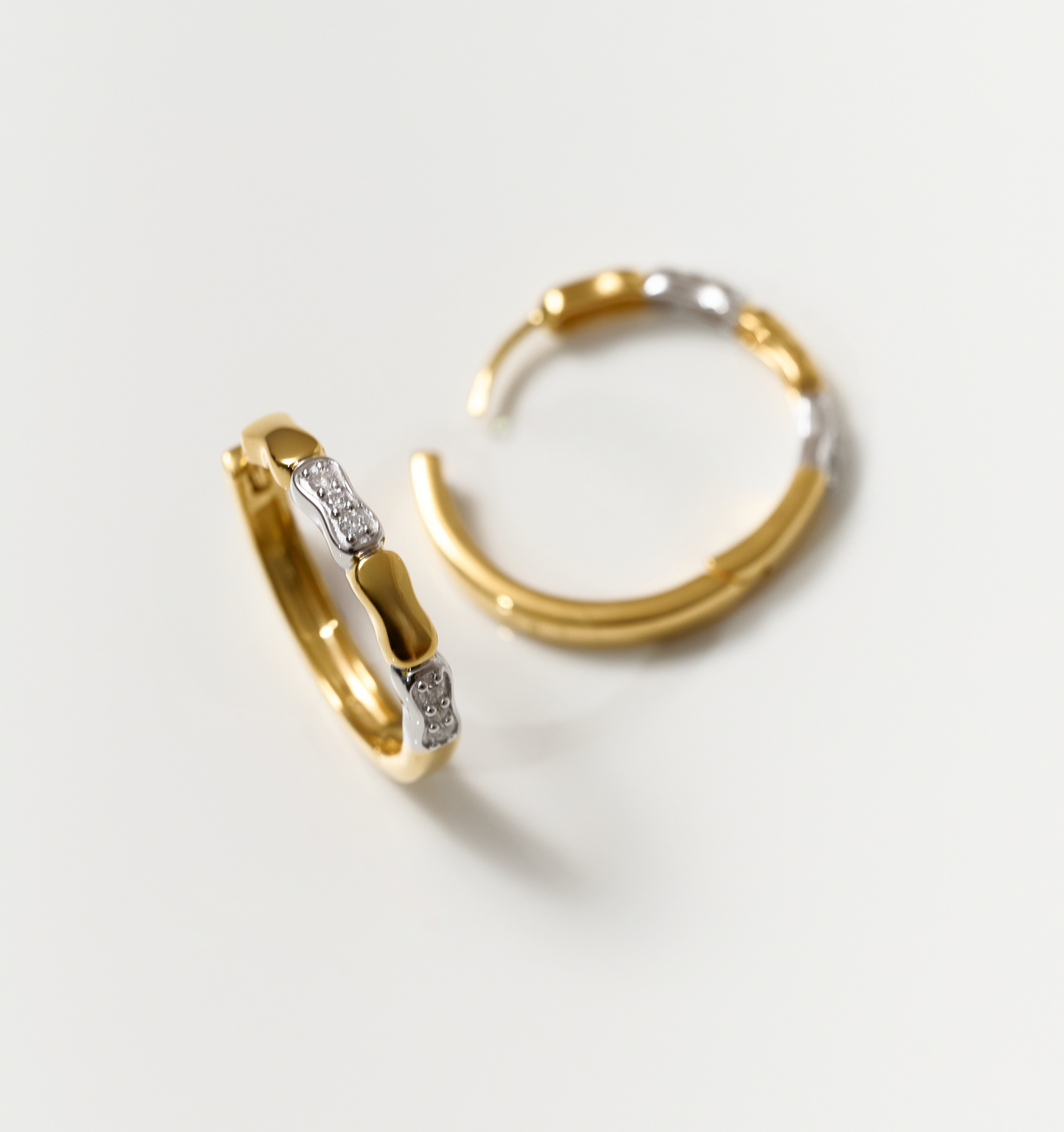 Orita Earrings gold and silver hoop with sparkling stones on white background