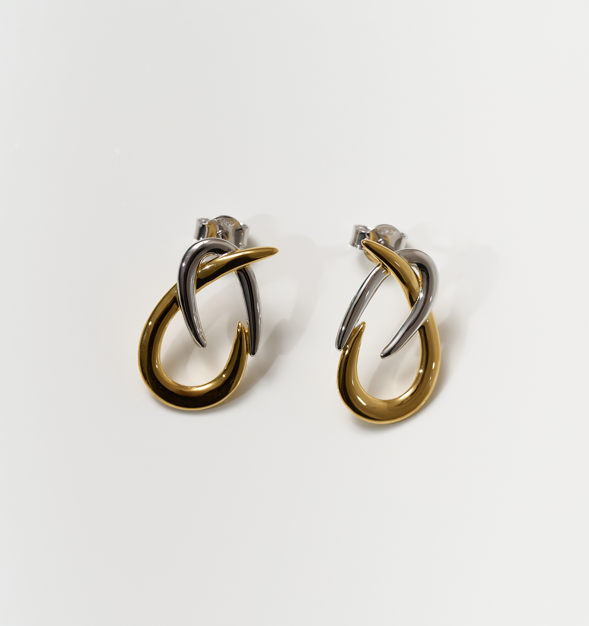 Syra Earrings gold and silver interlaced arcs minimal bold design