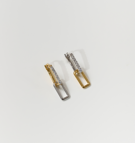 Bandha earrings two-tone gold and silver with embedded crystals on white background