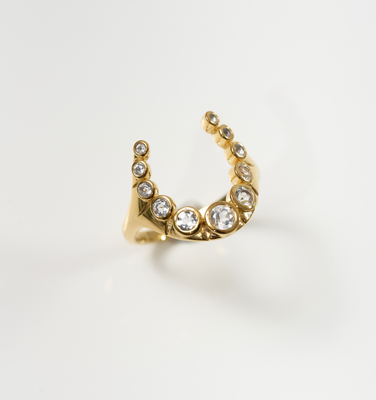 Rakira Ring gold crescent design with 11 white topaz stones symbolizing protection and pride