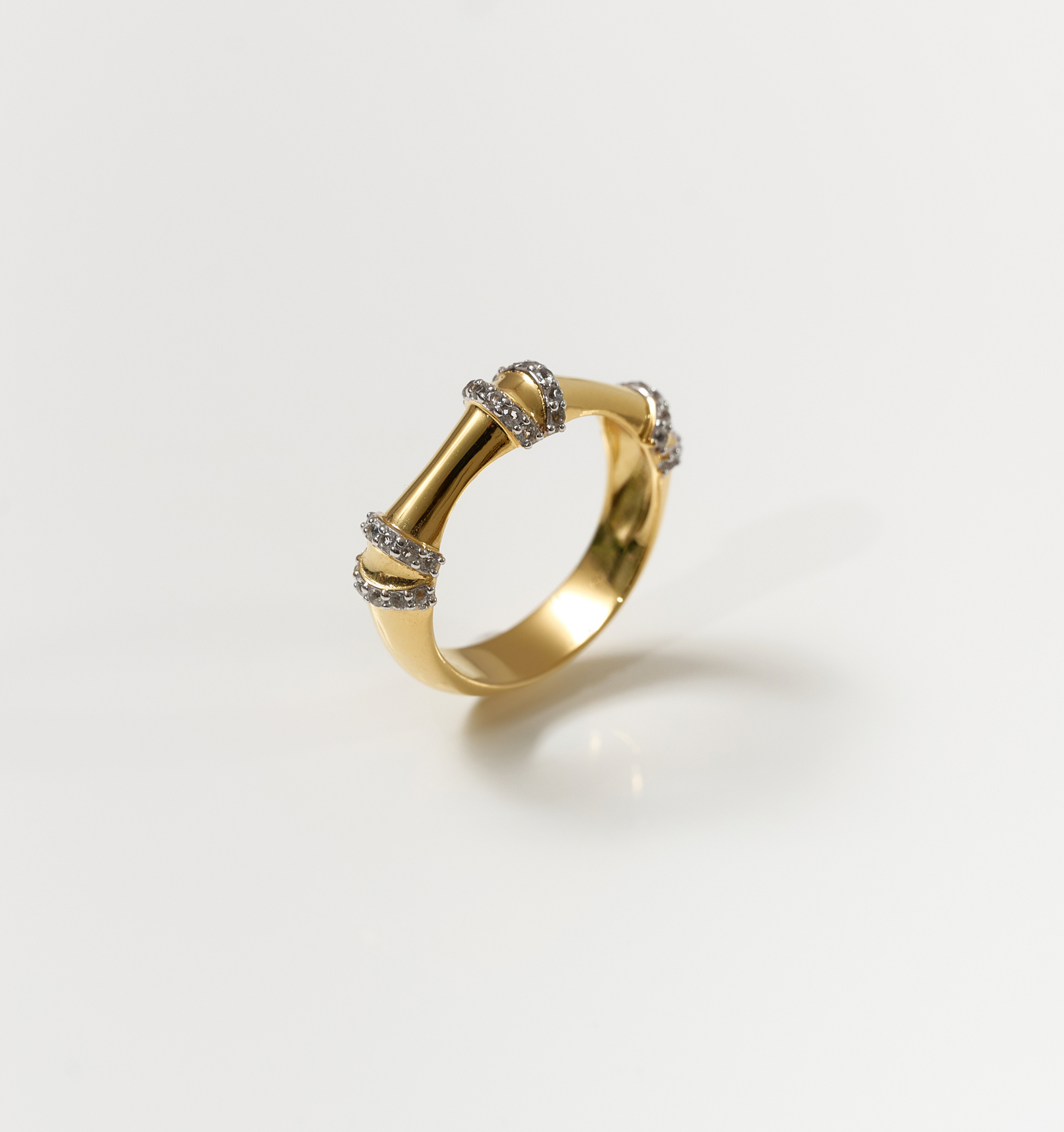 Ansh Ring gold band with white topaz accents inspired by bamboo strength and geometric design