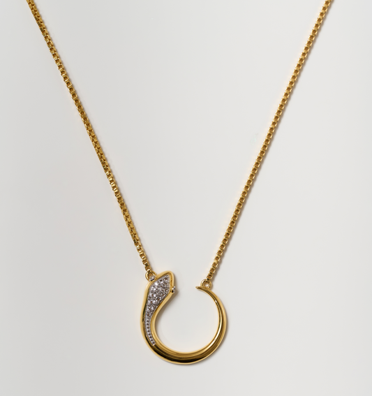 Oroha Necklace gold serpent pendant with white topaz on delicate chain symbolizing transformation and rebirth