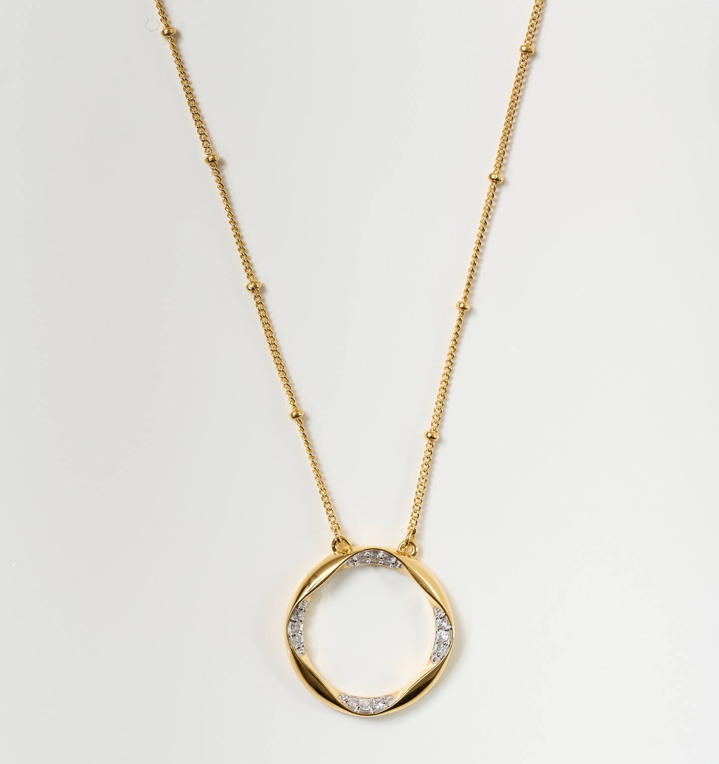 Taral Necklace gold chain with circular pendant featuring white topaz accents elegant jewelry piece