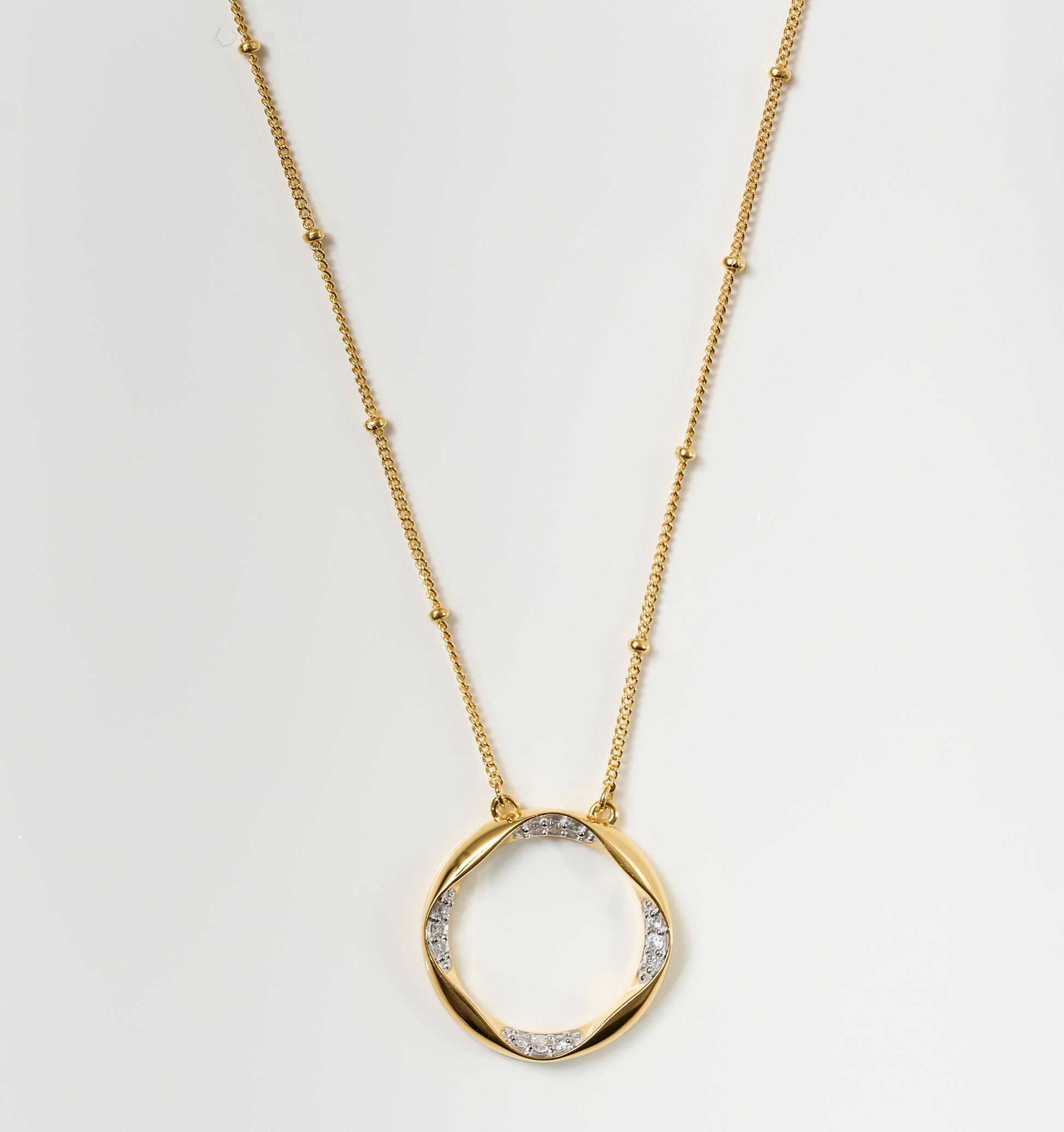 Taral Necklace gold chain with circular pendant featuring white topaz accents elegant jewelry piece