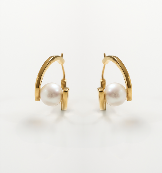 Gold Sharvani Earrings with a pearl accent and horned curve design on white background