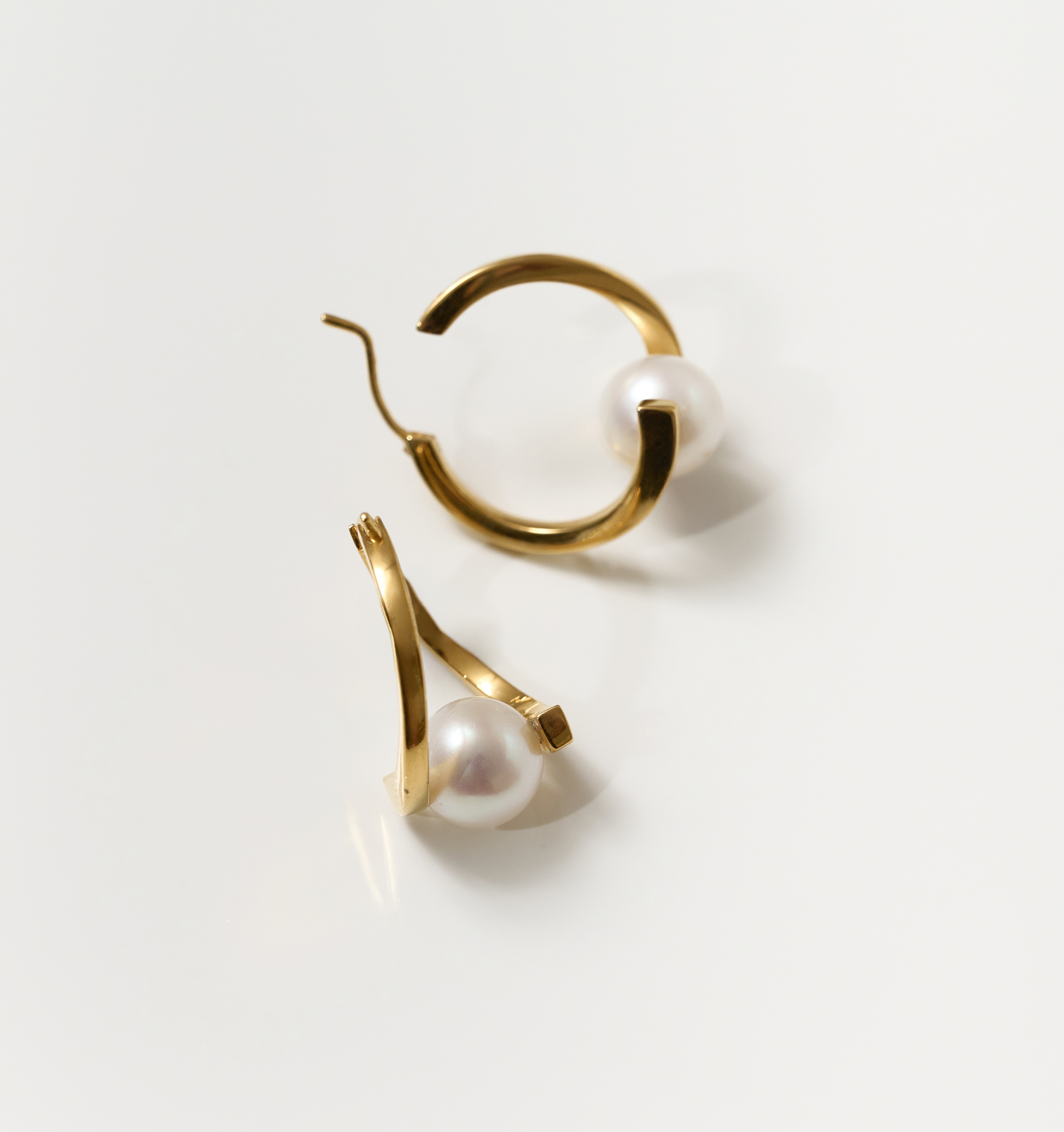 Gold Sharvani earrings with pearls, featuring a curved horned design symbolizing strength and elegance