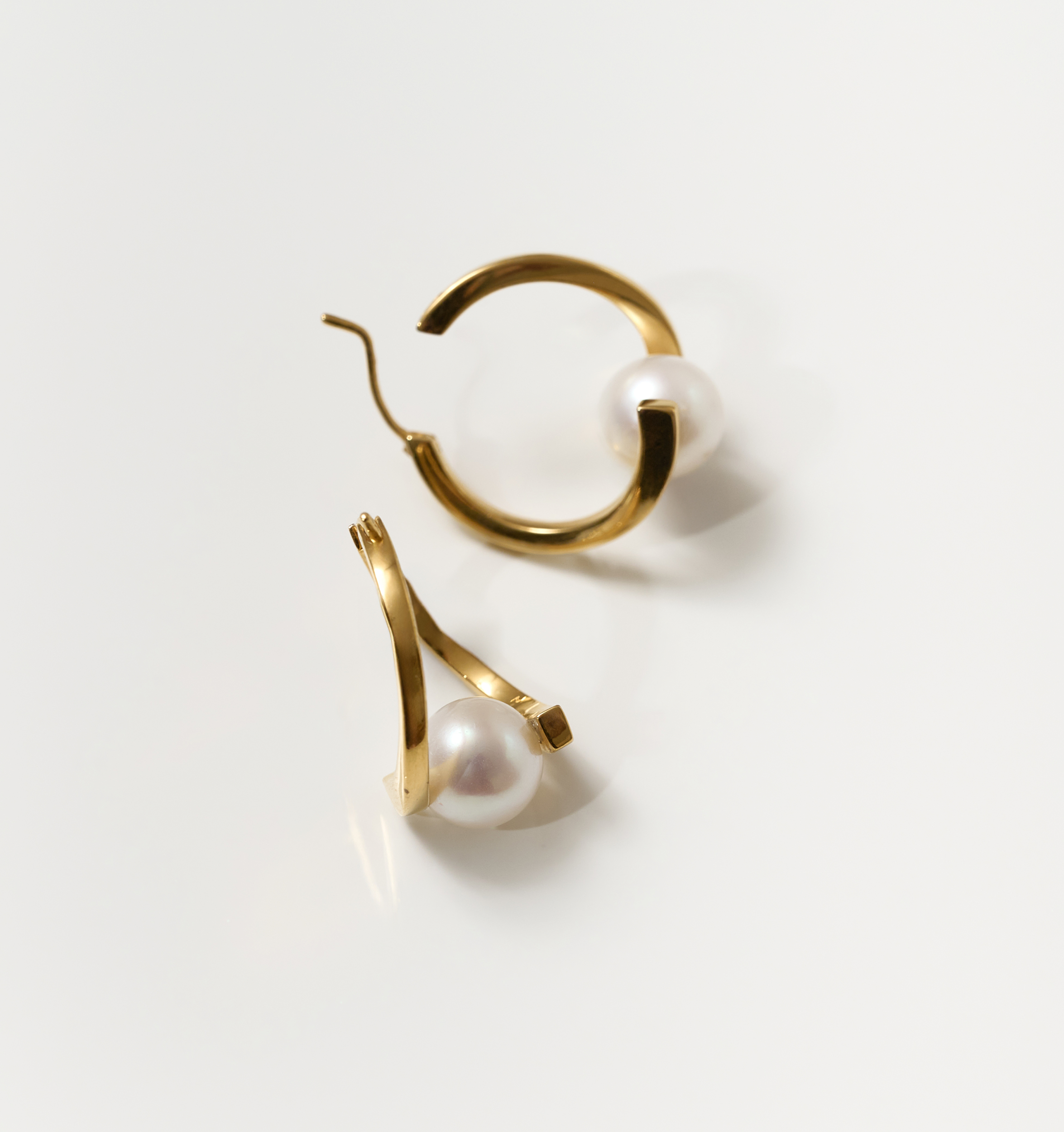 Gold Sharvani earrings with pearls, featuring a curved horned design symbolizing strength and elegance