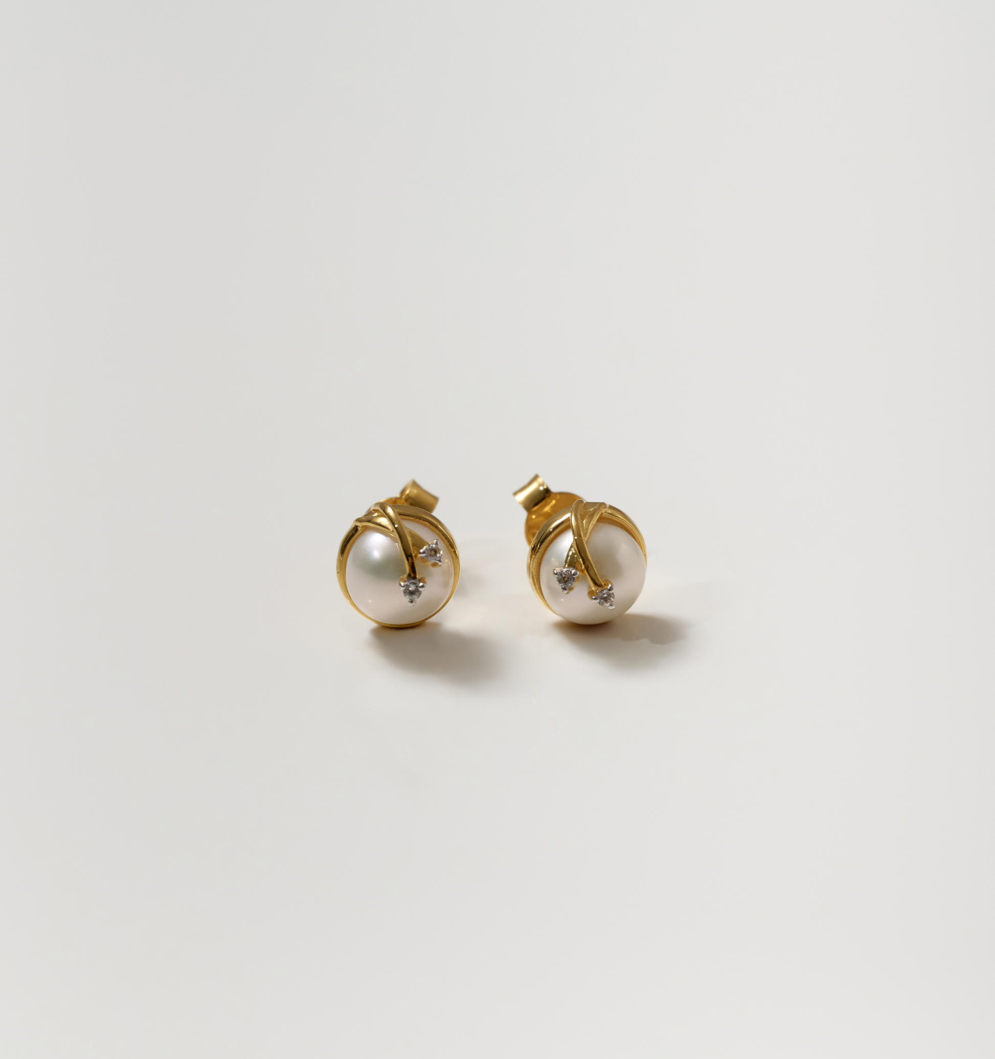 Poorna Earrings gold studs with pearl and star design symbolizing completeness