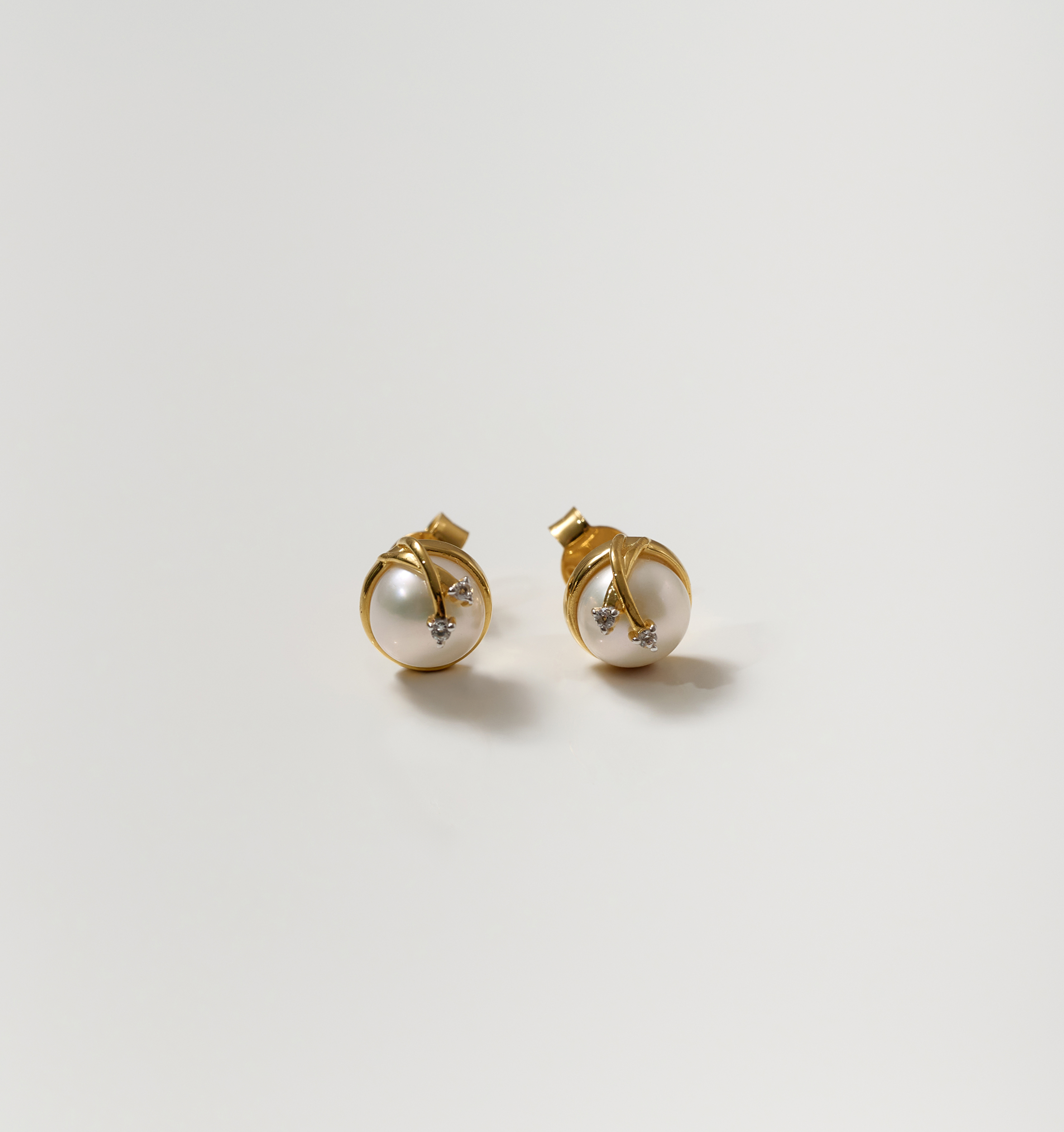 Poorna Earrings gold studs with pearl and star design symbolizing completeness