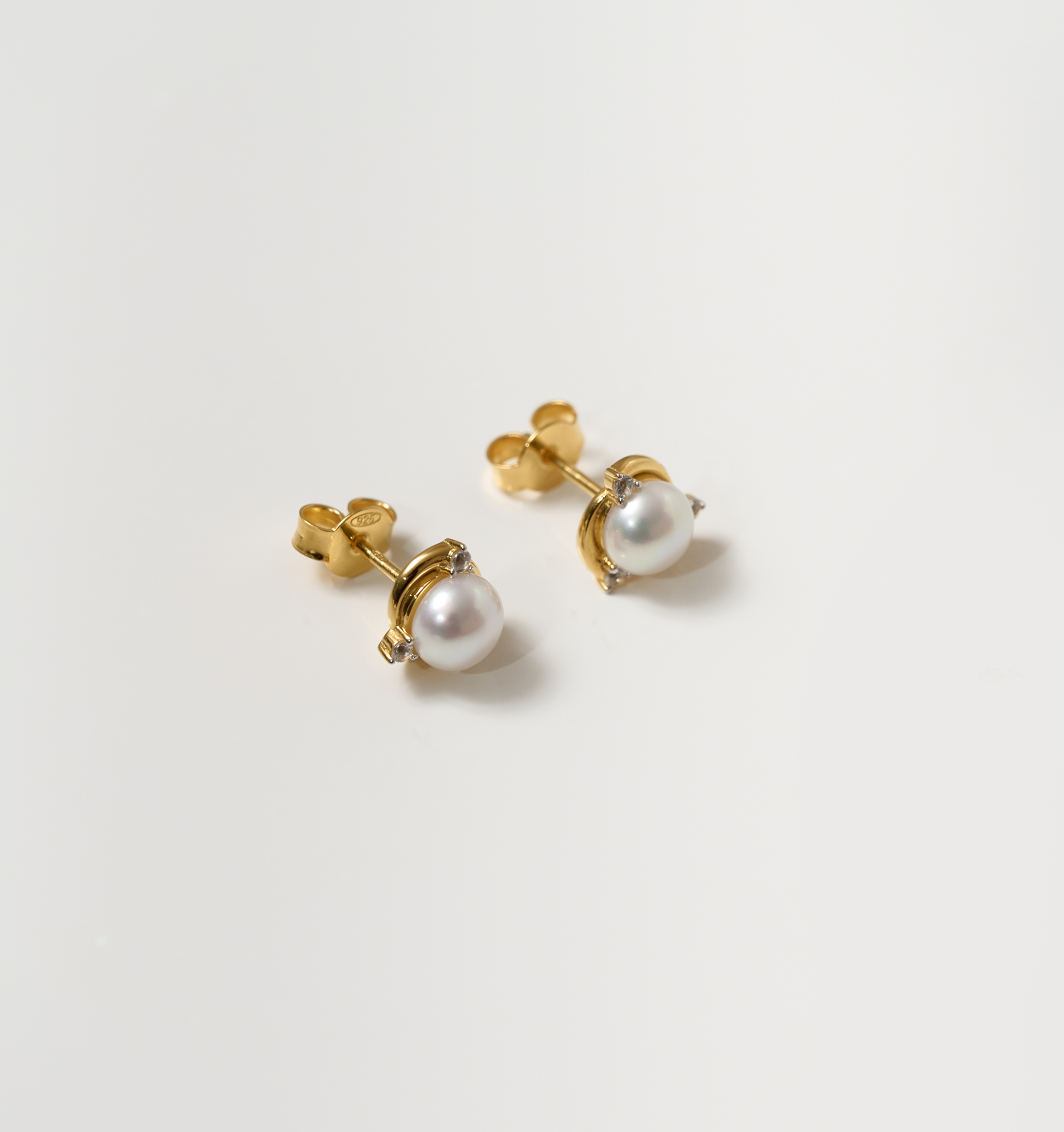 Nayana Earrings with single pearl and topaz set in gold stud design