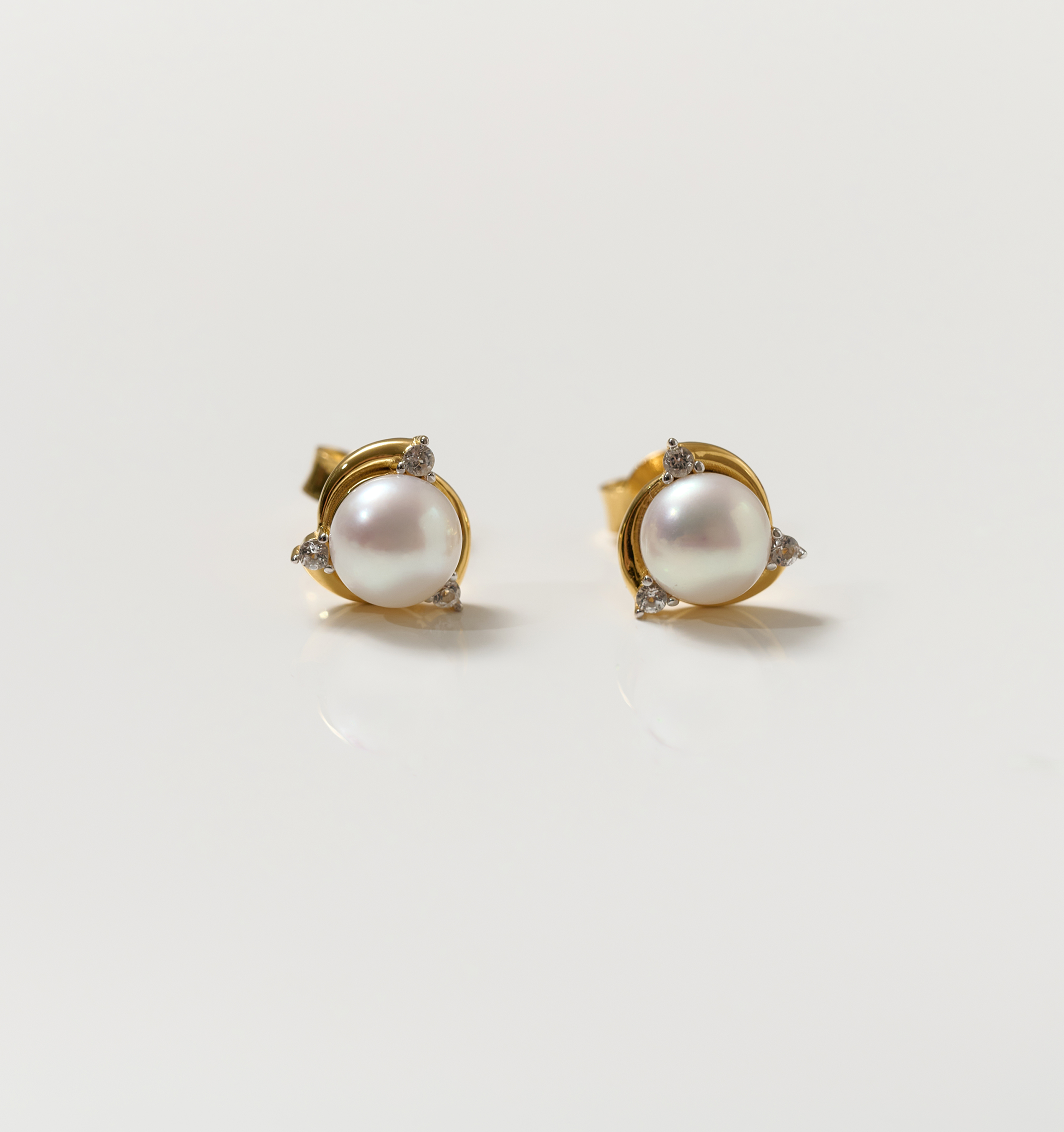 Nayana Earrings featuring pearls and topaz set in gold studs for elegant calm and clarity