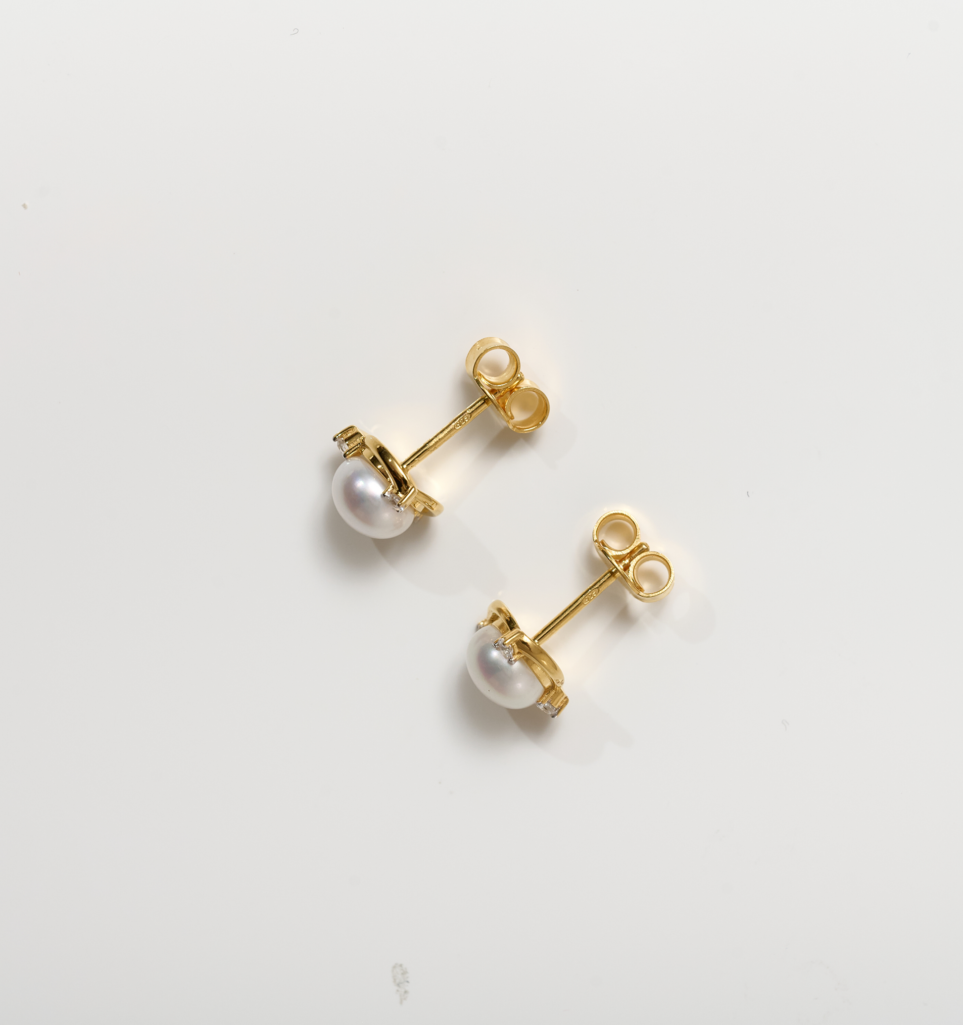 Nayana Earrings gold studs with pearls and topaz gemstones on white background