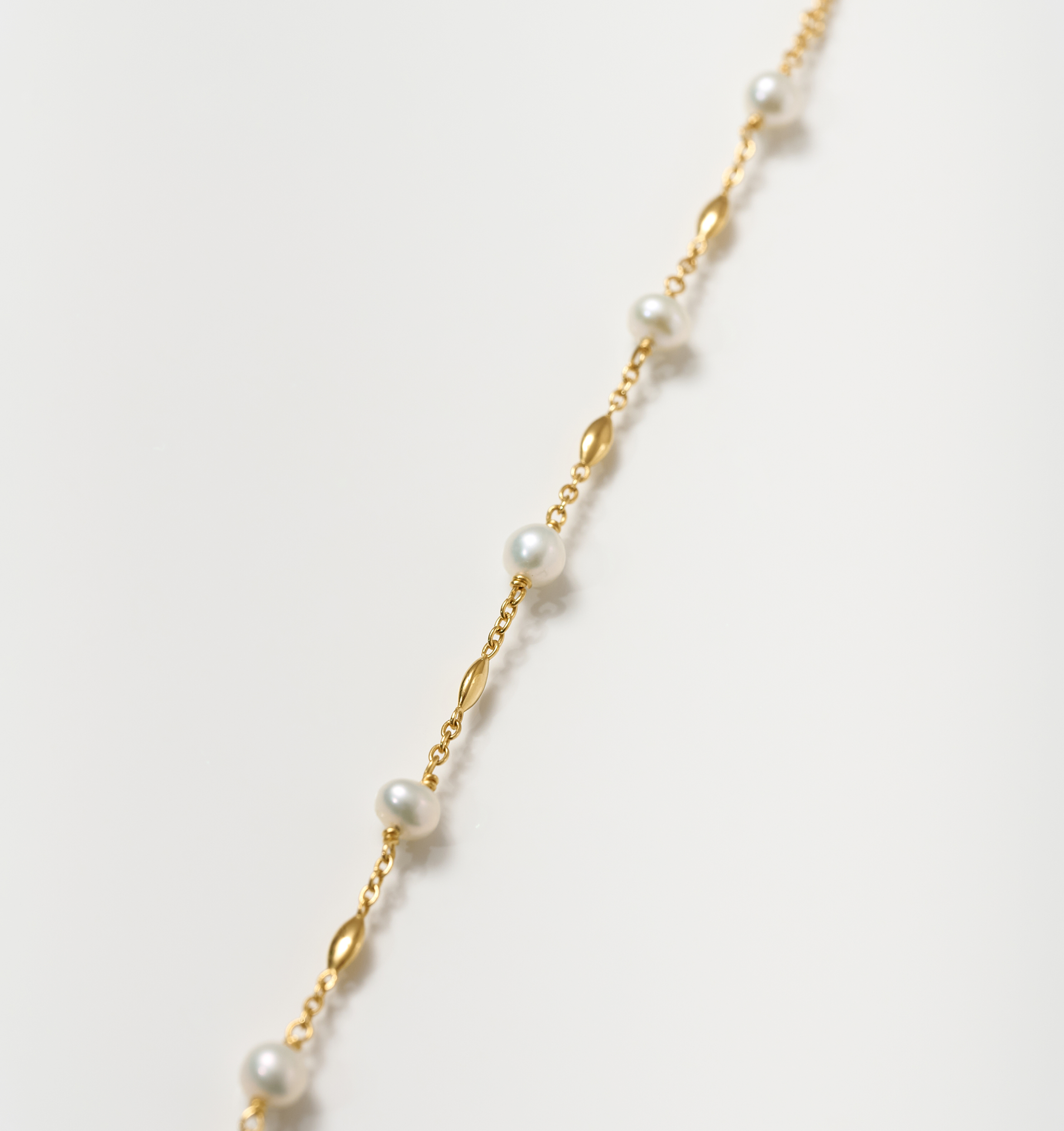 Manjari Necklace featuring five pearls spaced with gold beads on a delicate chain