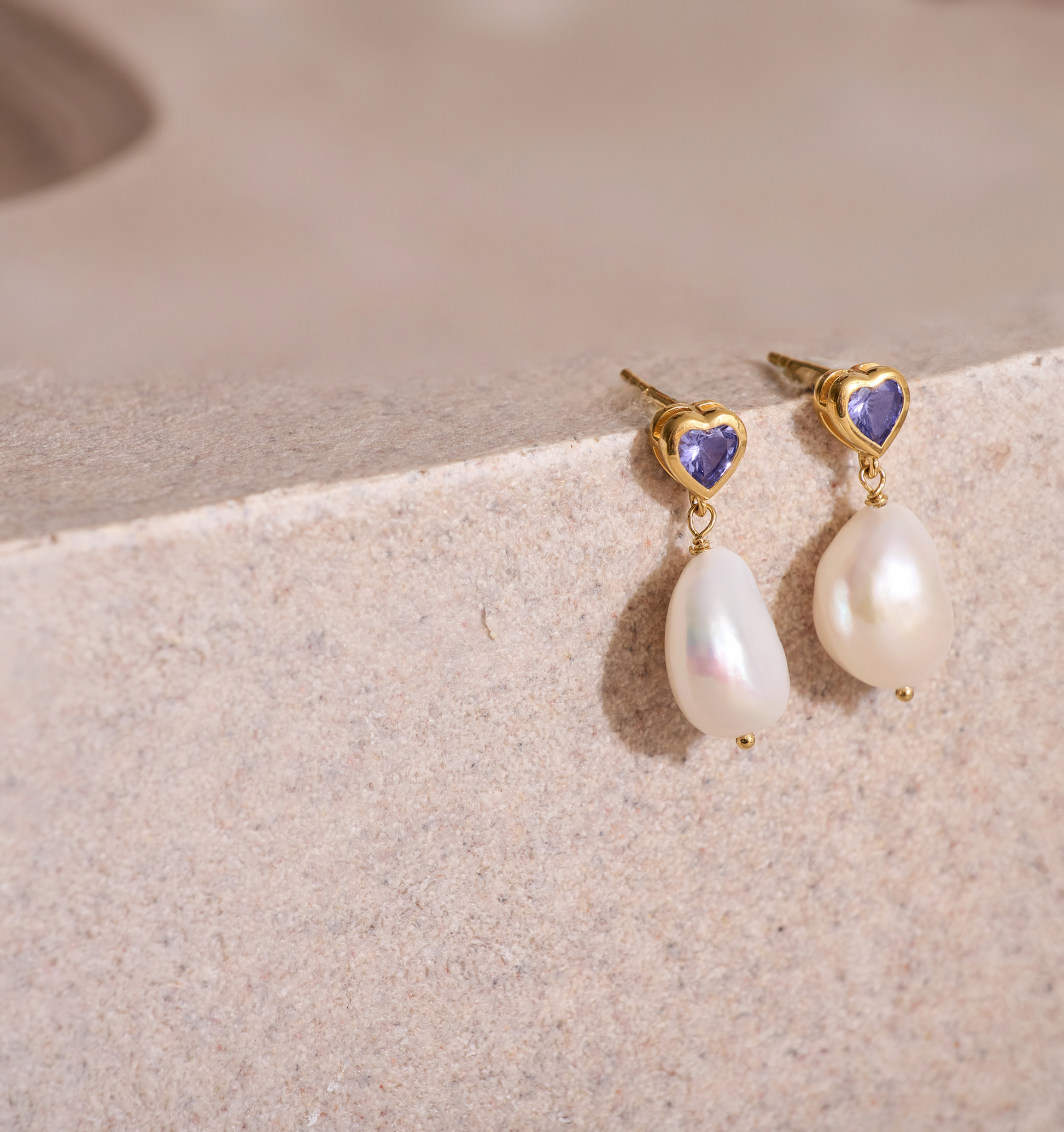 Hridaya Earrings with heart-shaped tanzanite and dangling pearls in gold setting