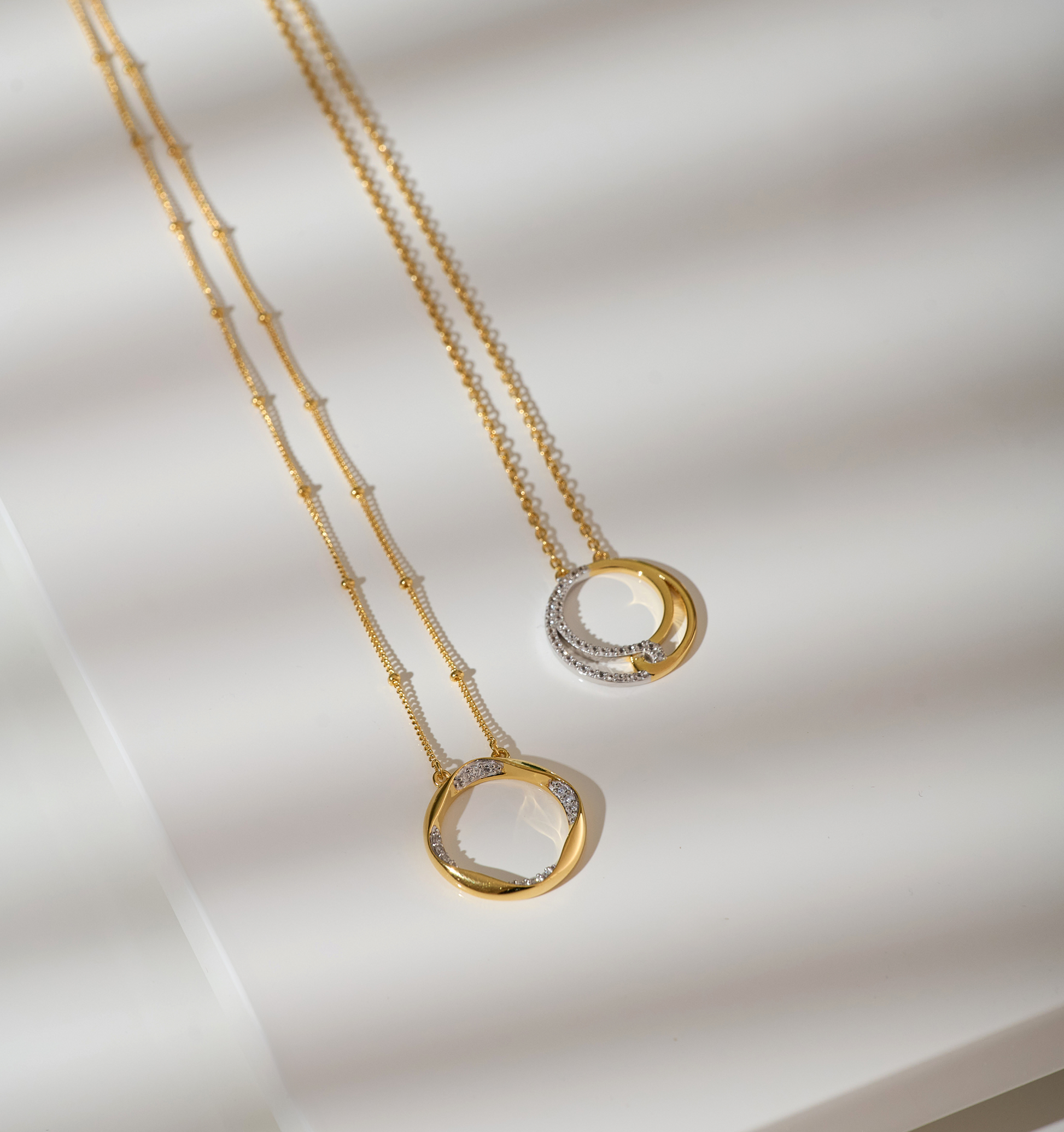 Taral Necklace featuring delicate gold and white topaz pendant with elegant circular design on fine gold chain