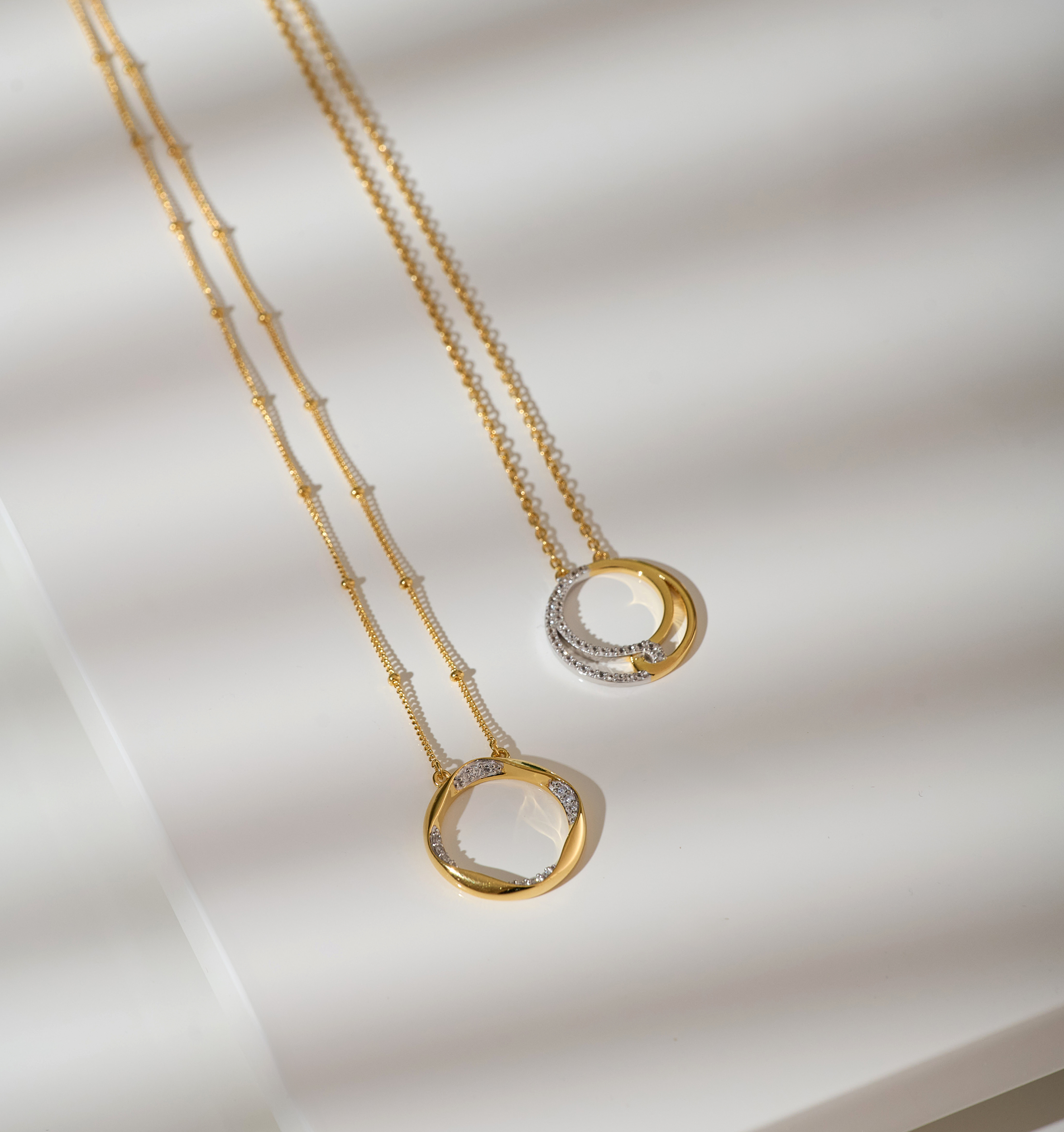 Taral Necklace featuring delicate gold and white topaz pendant with elegant circular design on fine gold chain