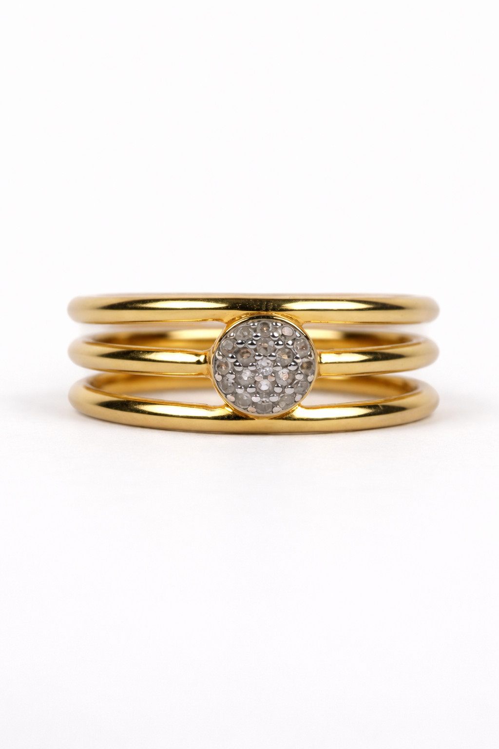 Trinetra Ring featuring three golden bands with a radiant white topaz top symbolizing inner sight and clarity