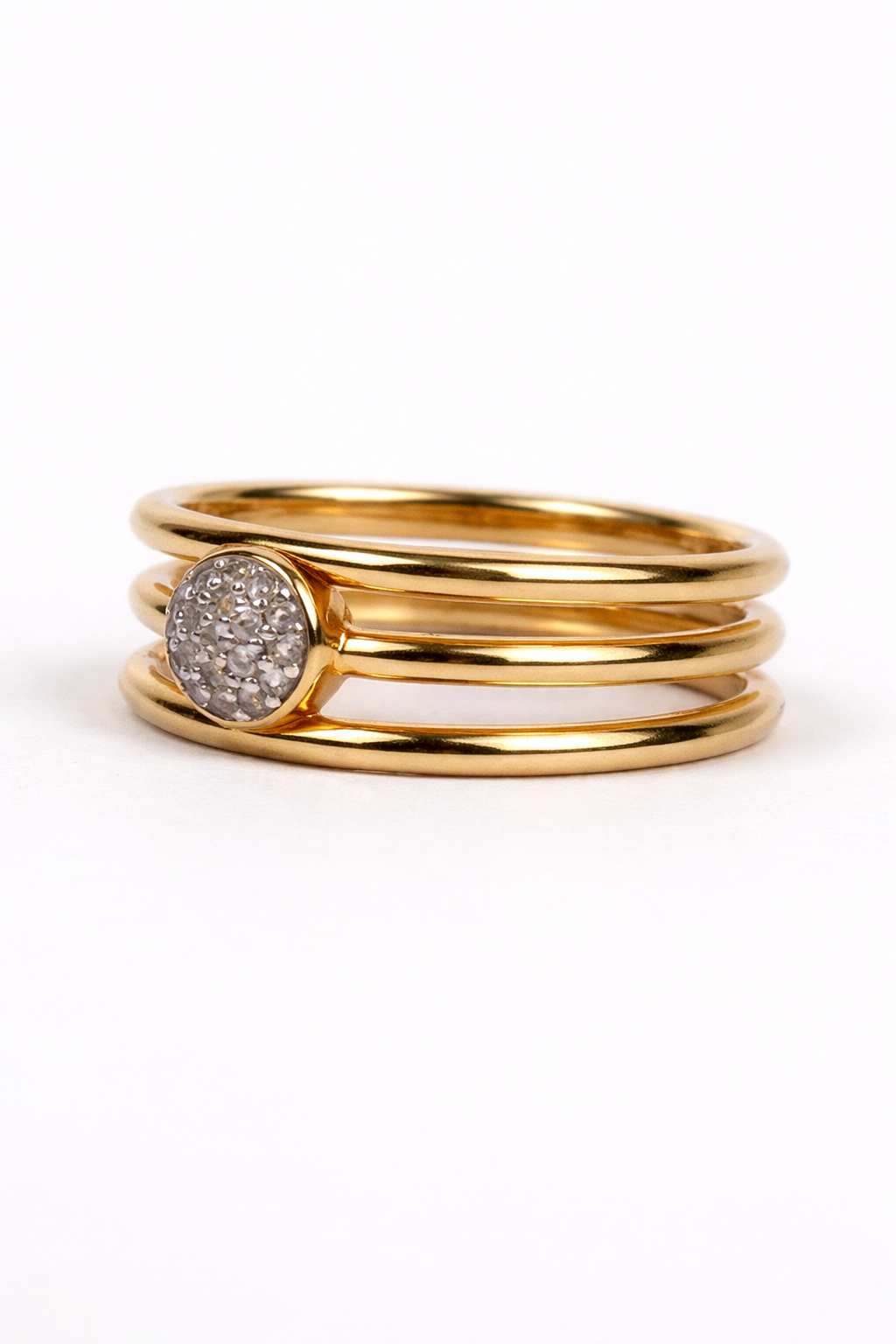 Trinetra Ring with three golden bands and radiant white topaz symbolizing inner sight and clarity