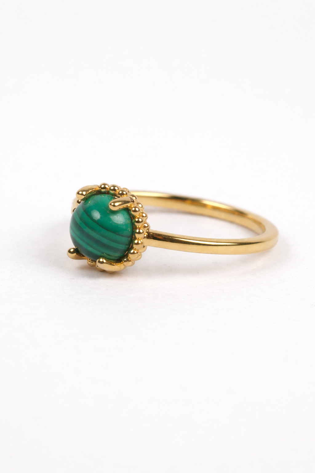 Vanya Ring with smooth round malachite stone on a sleek gold band displaying natural green bands