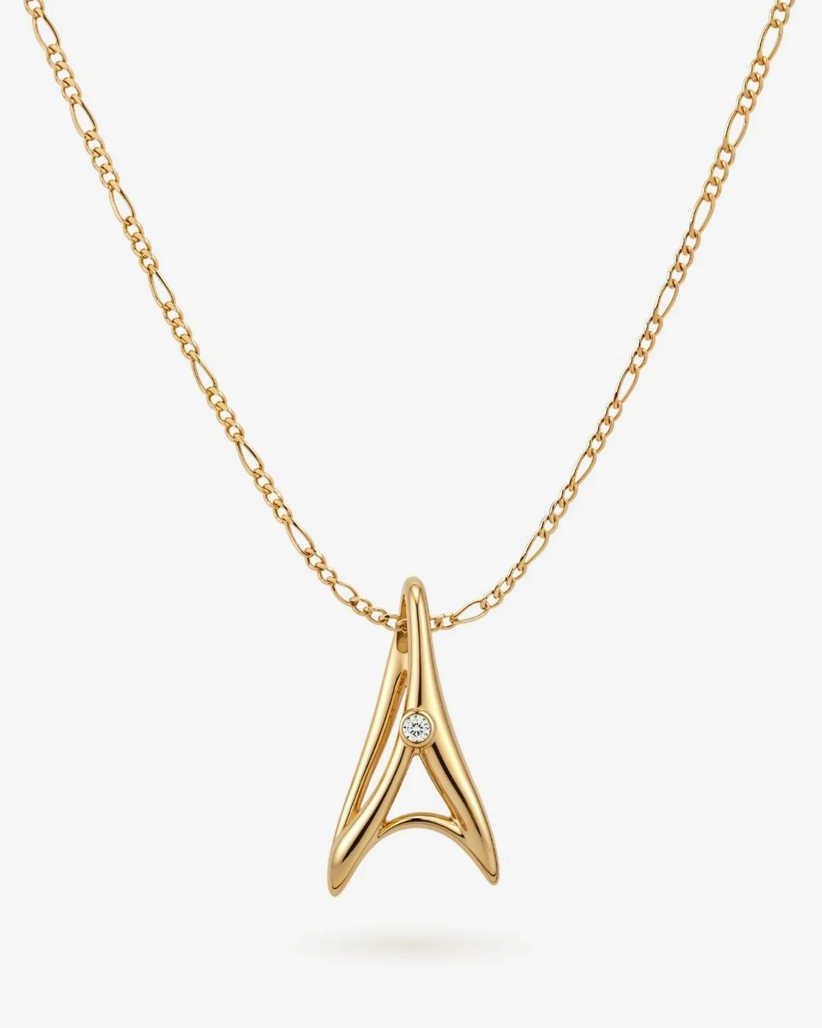 A ए Initial Necklace in polished gold-tone metal with a sculptural letter A pendant and a small clear stone detail.