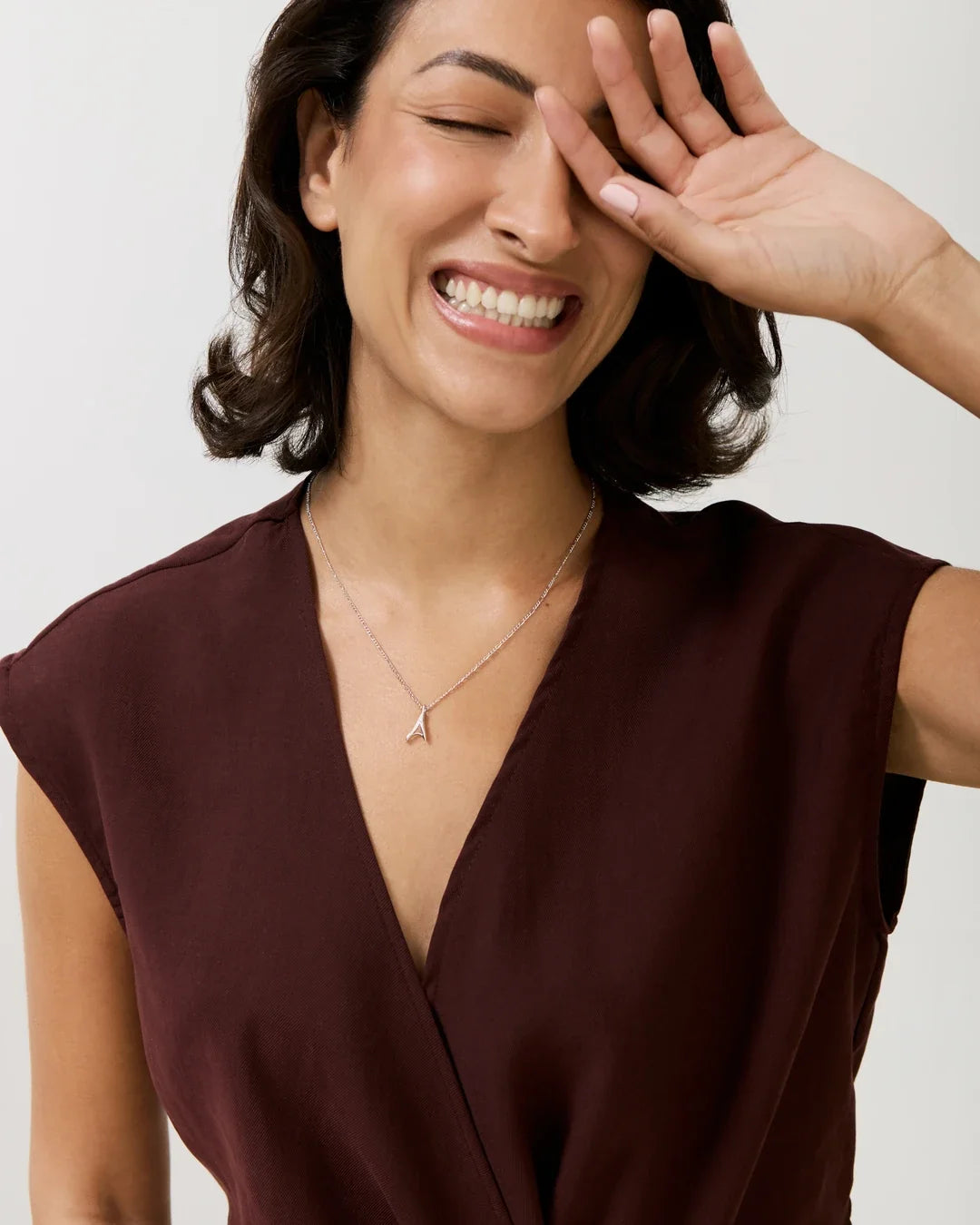 A ए Initial Necklace in delicate gold-tone metal, featuring a small letter A pendant on a fine chain