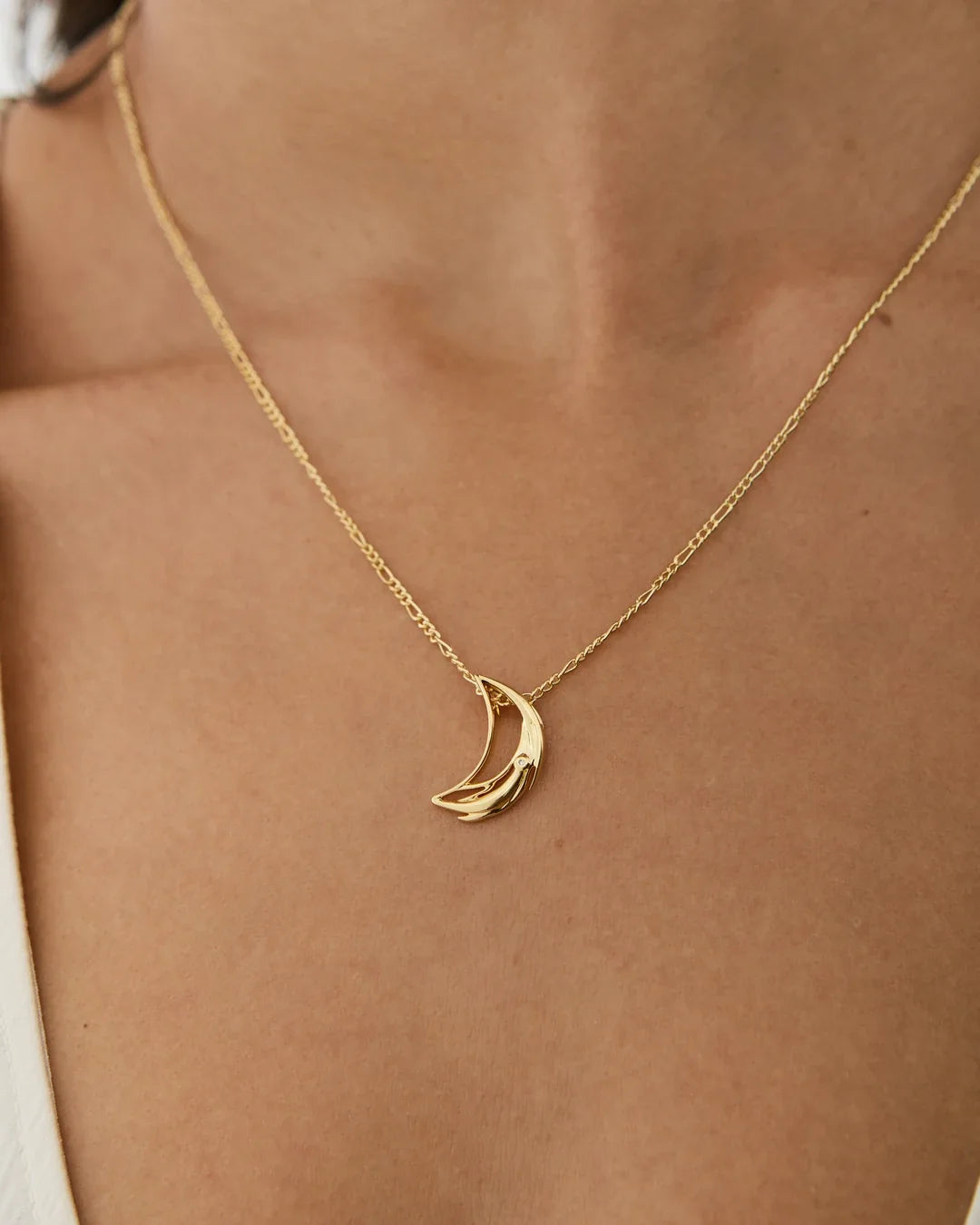 D डी Initial Necklace in gold-toned metal with a fine chain and polished crescent-shaped pendant.
