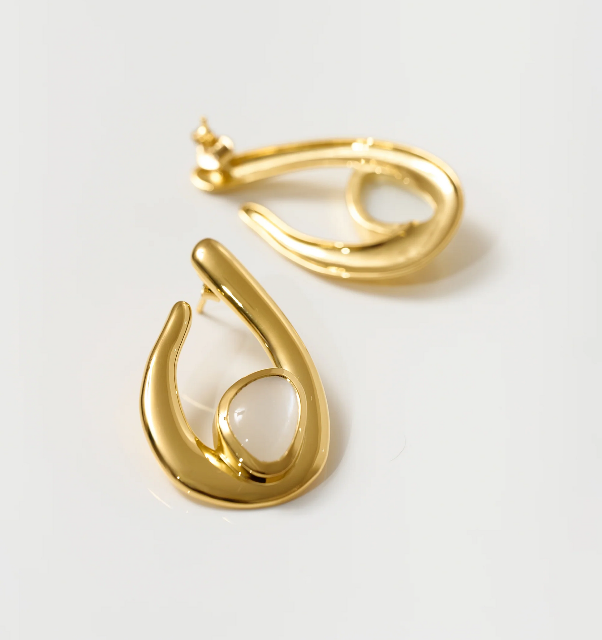 Lunara Earrings gold sculptural design with luminous white moonstone centerpiece