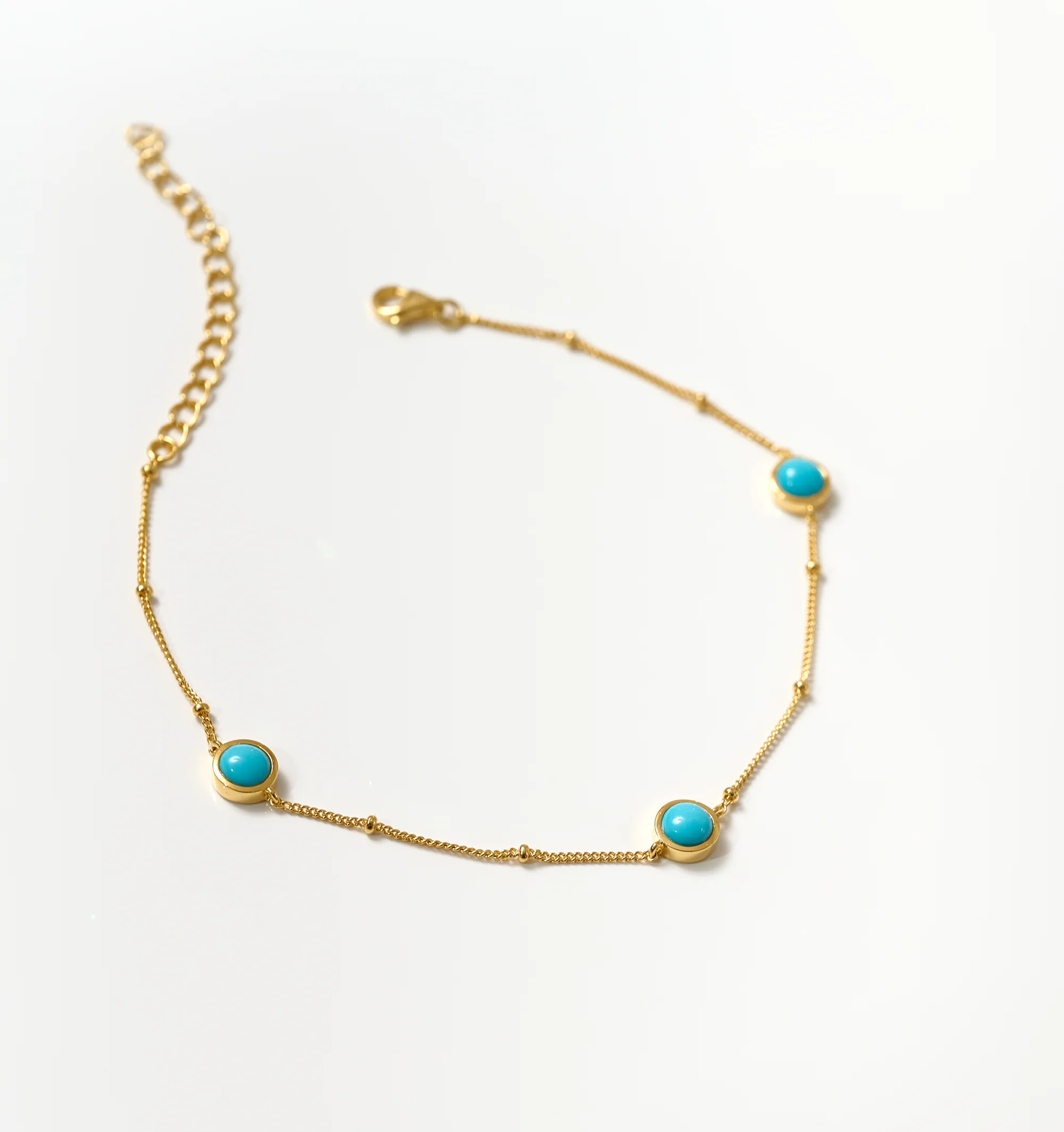 Nilaaya Bracelet delicate gold chain with three turquoise stones on white background