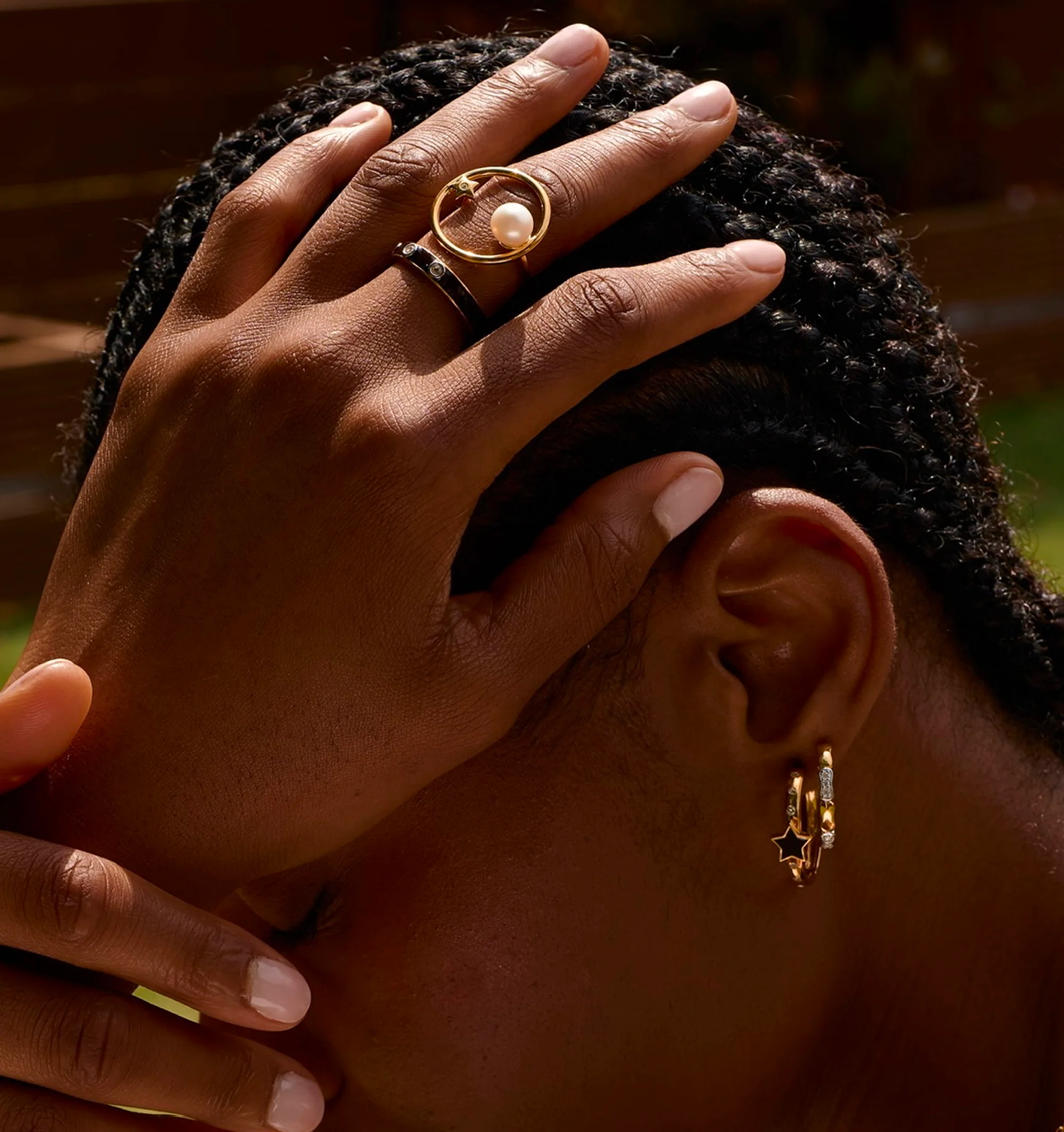 Close-up of hand wearing Trikaala Ring with white stone, symbolizing time and reflection
