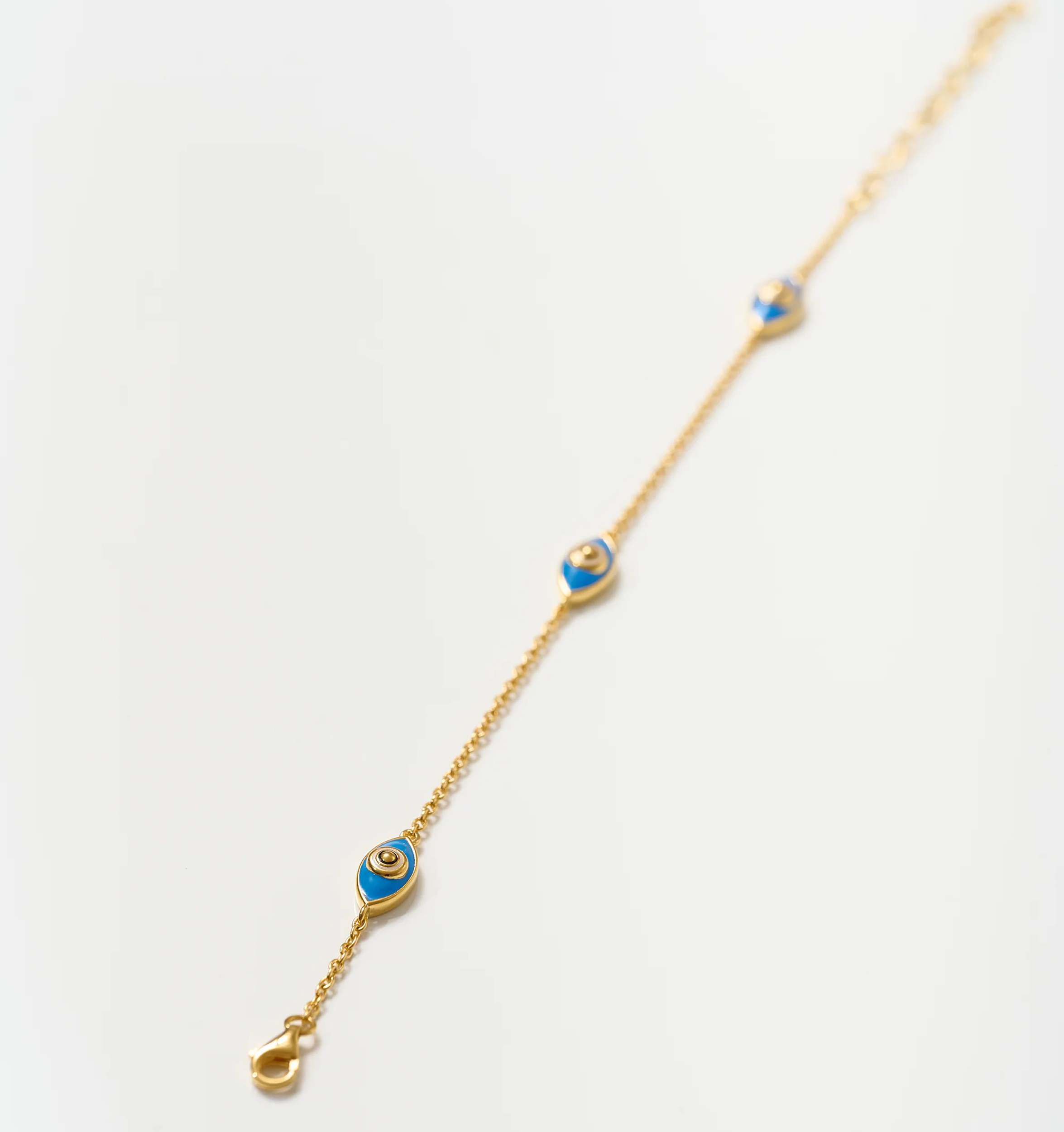 Dhrish Bracelet gold chain with turquoise enamel eye charms symbolizing clarity and protection