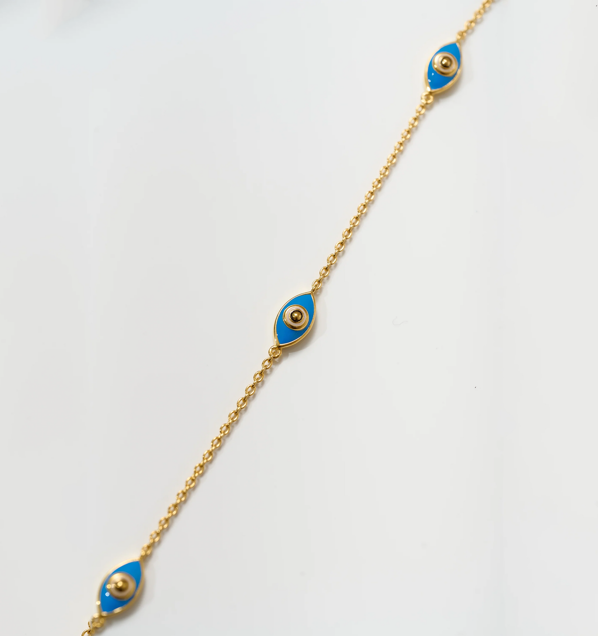 Dhrish Bracelet gold chain with turquoise enamel eye charms symbolizing clarity and protection