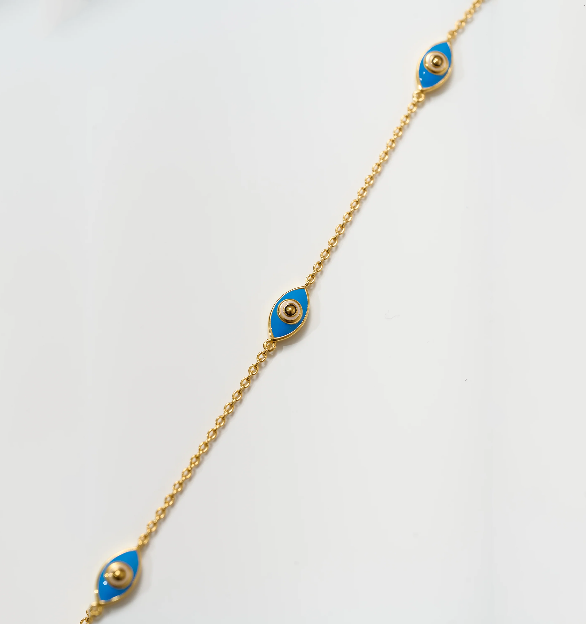 Dhrish Bracelet gold chain with turquoise enamel eye charms symbolizing clarity and protection