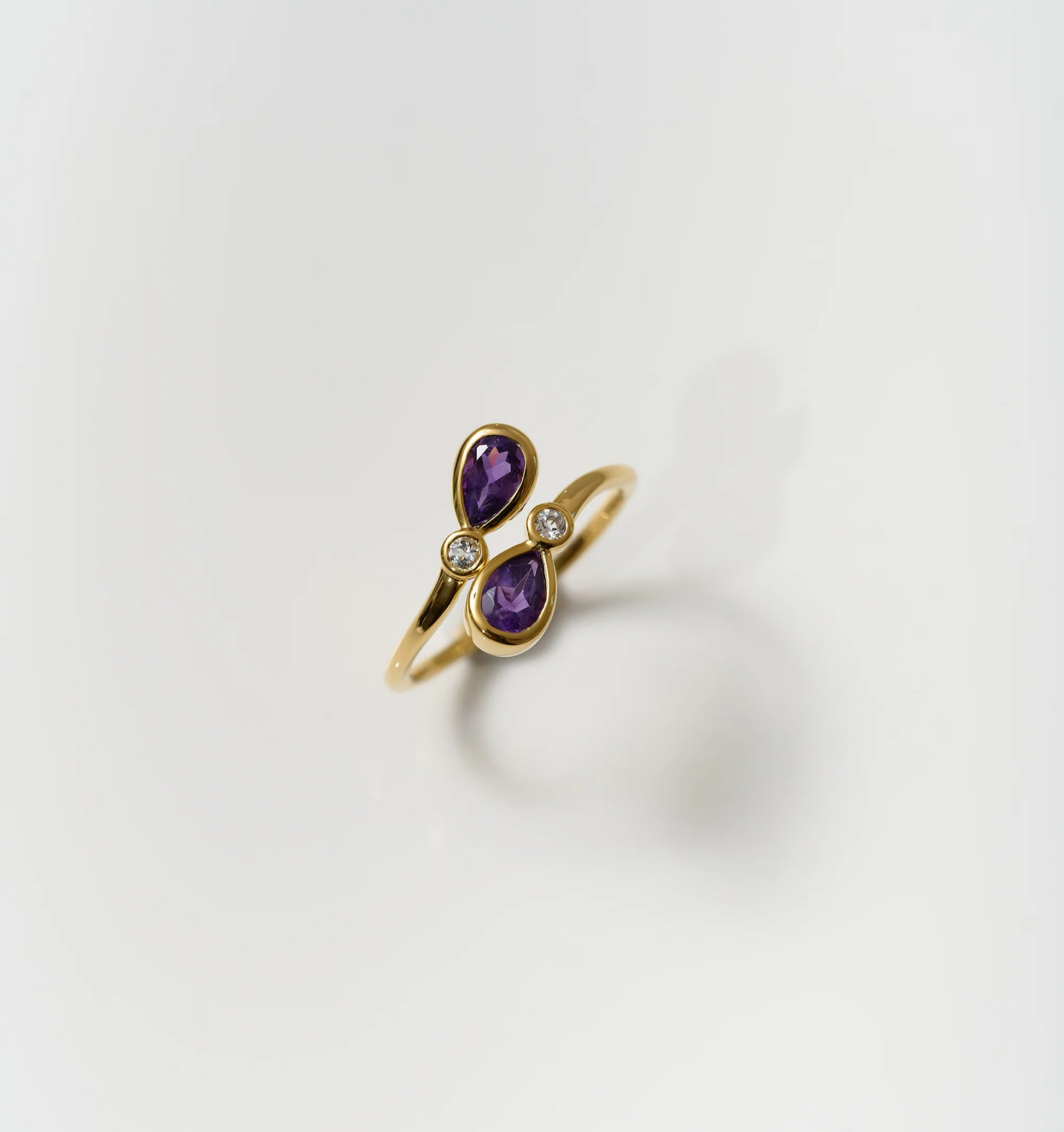 Nimira Ring with twin amethysts and white topaz set in gold band