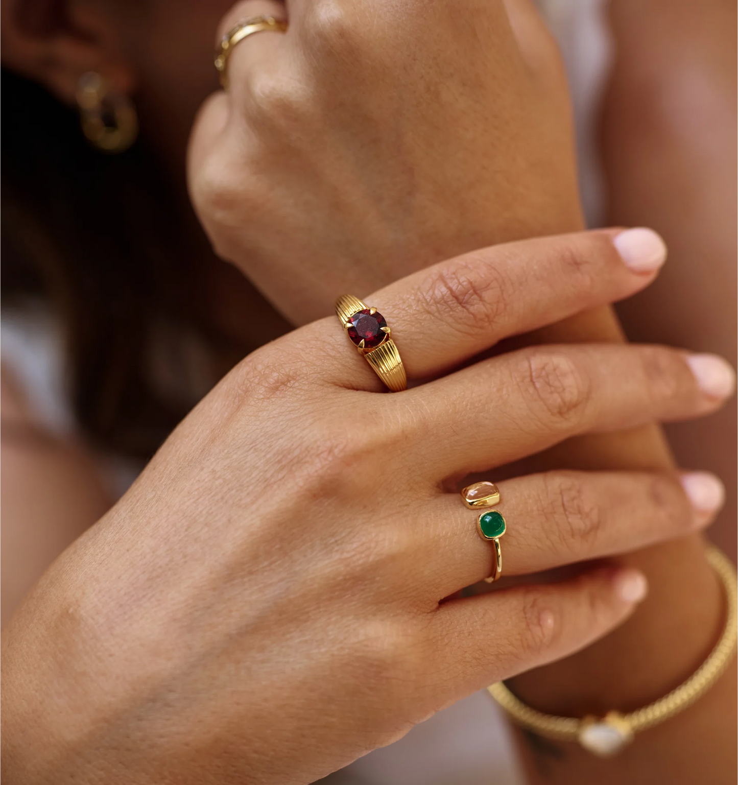 Tulaa Ring with green onyx and morganite gemstones set in gold on hand