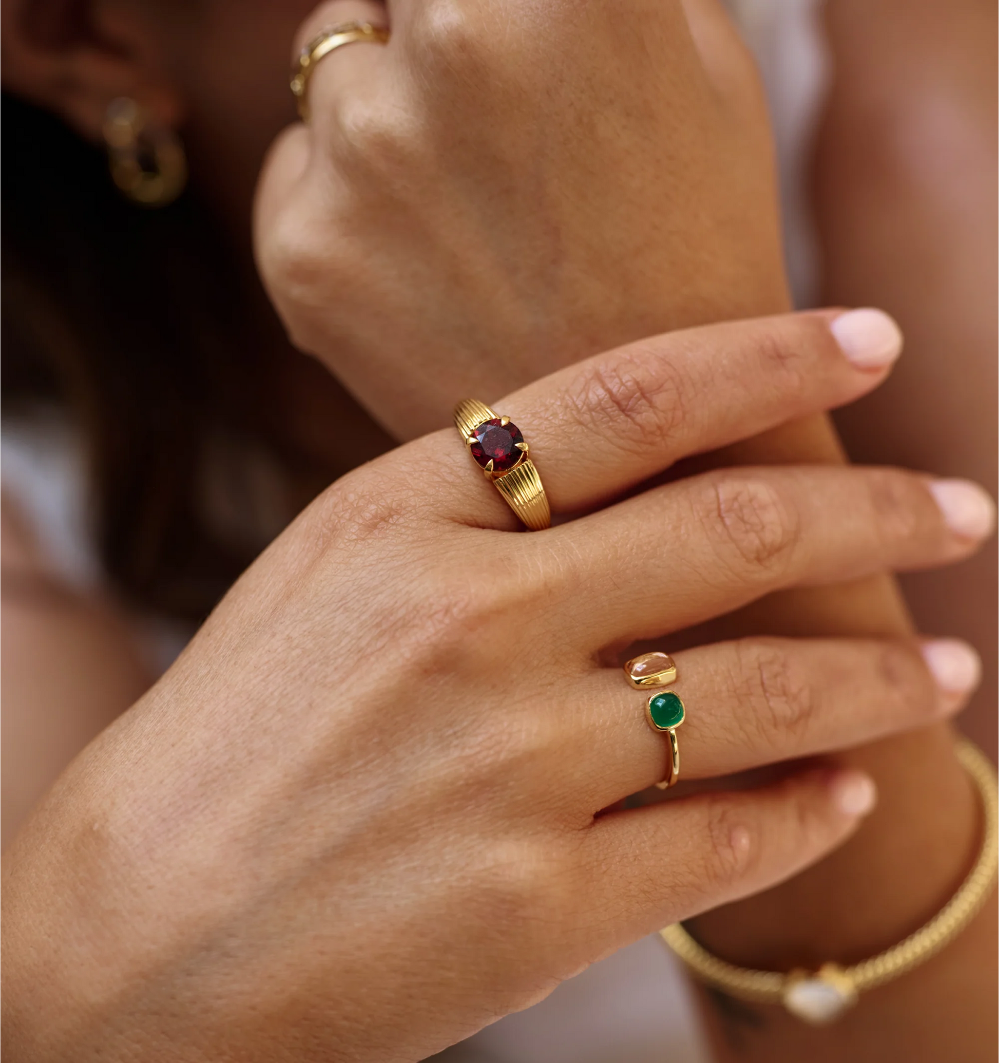 Tulaa Ring with green onyx and morganite gemstones set in gold on hand