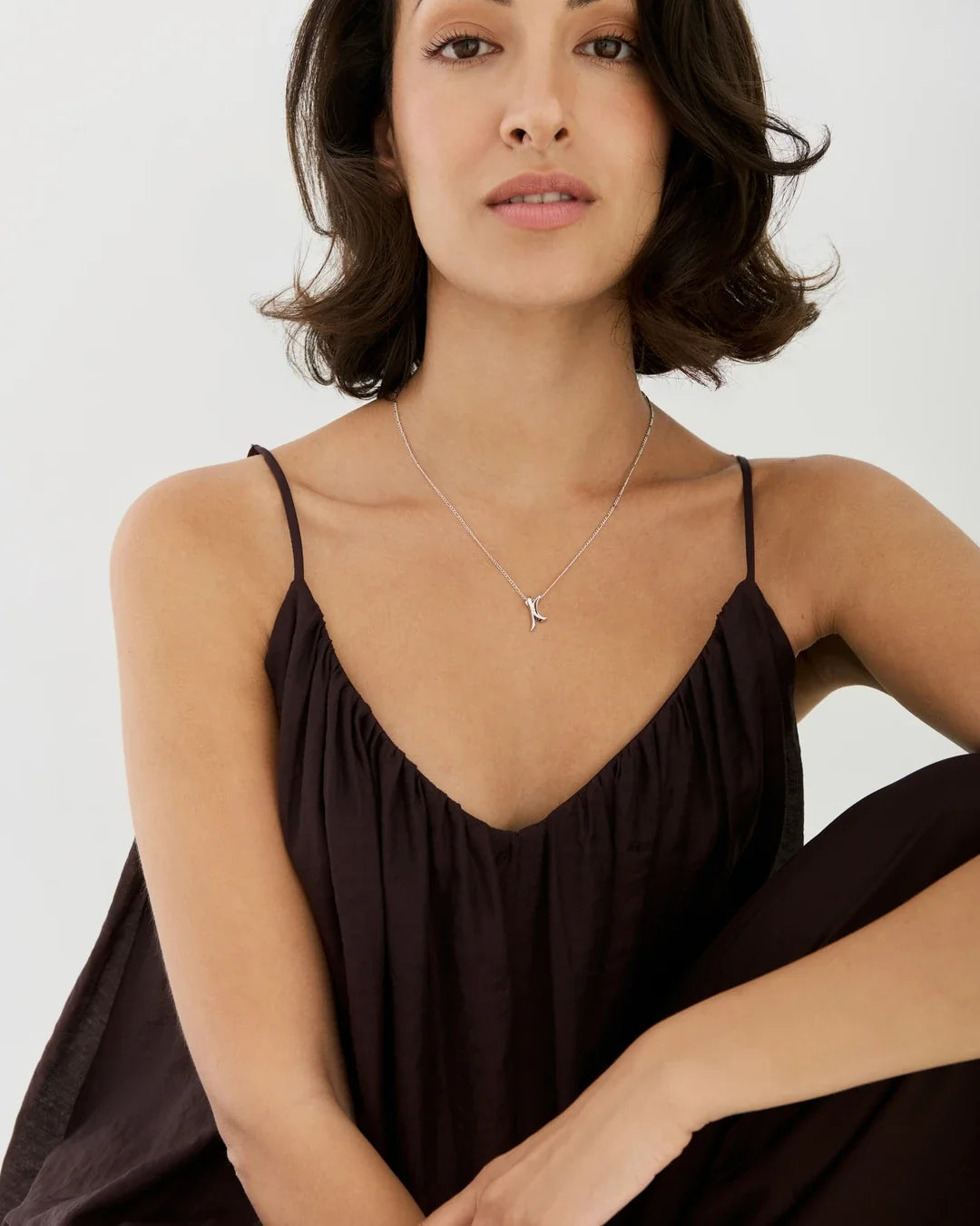 K के Initial Necklace in delicate silver-toned metal, with a fine chain and a small K-shaped pendant
