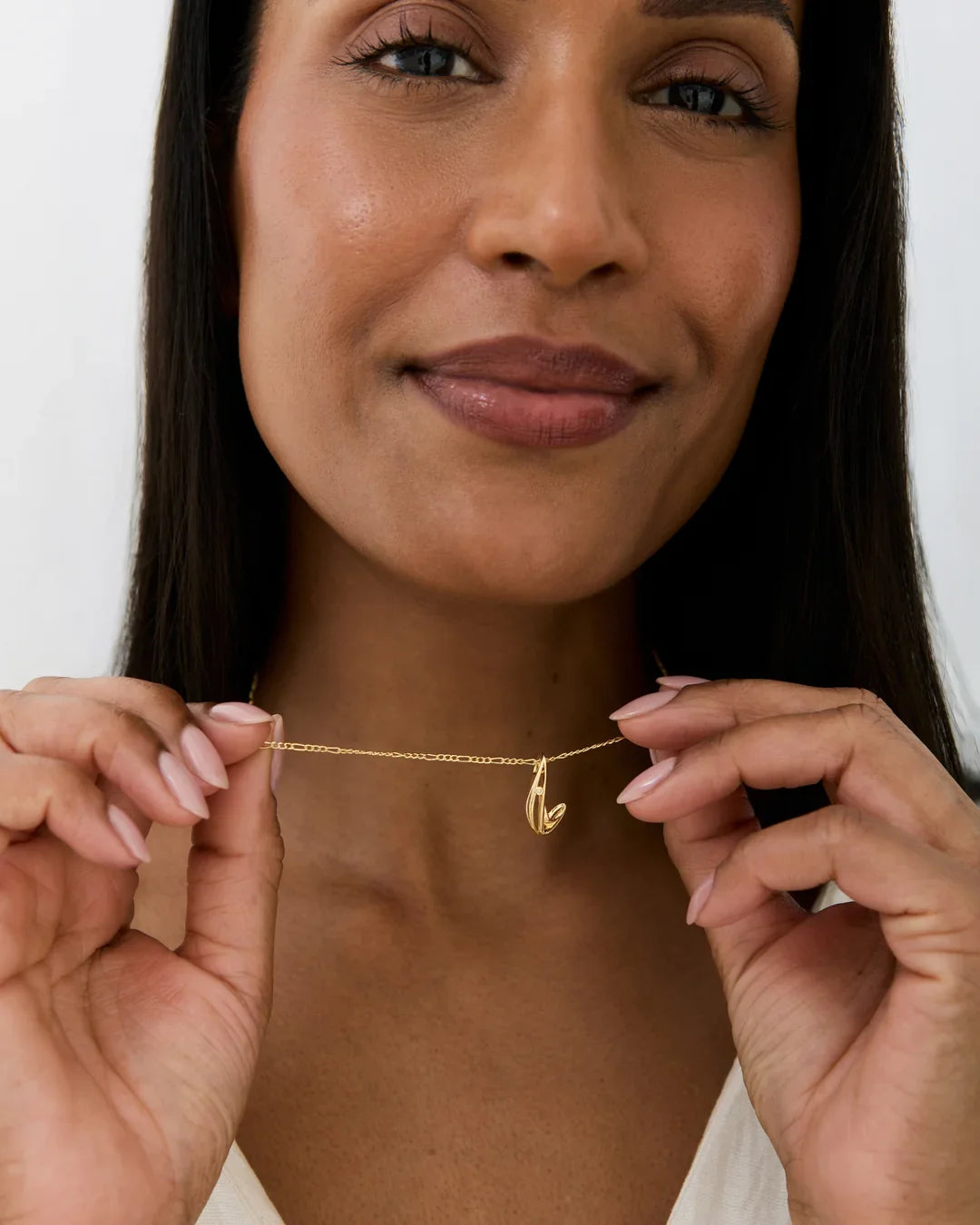 Gold-tone L एल Initial Necklace with a fine chain and a slim, upright letter L pendant with a shadow-like curve.