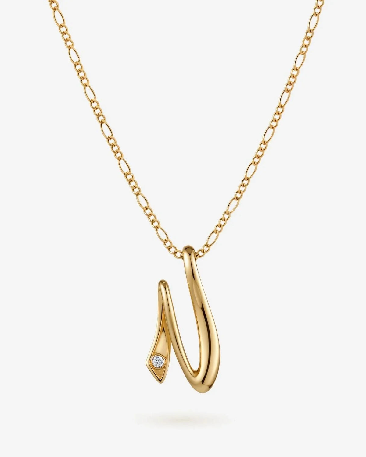 N एन Initial Necklace in gold-tone metal, featuring a polished sculptural N pendant with a small clear stone accent.