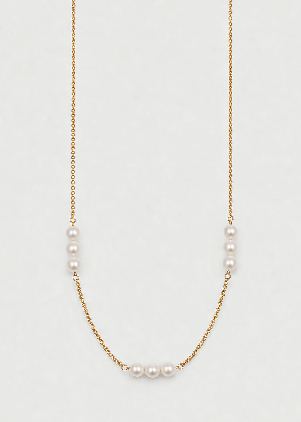 Navya Necklace with nine pearls arranged in balanced groups of three, showcasing modern elegance and classic design