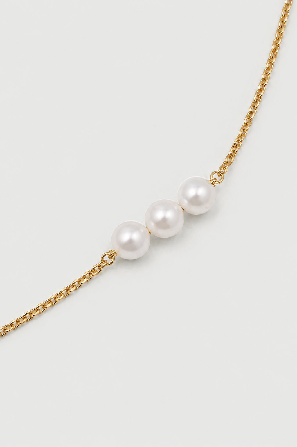 Navya Necklace with nine pearls arranged in balanced groups of three, showcasing modern classic elegance.