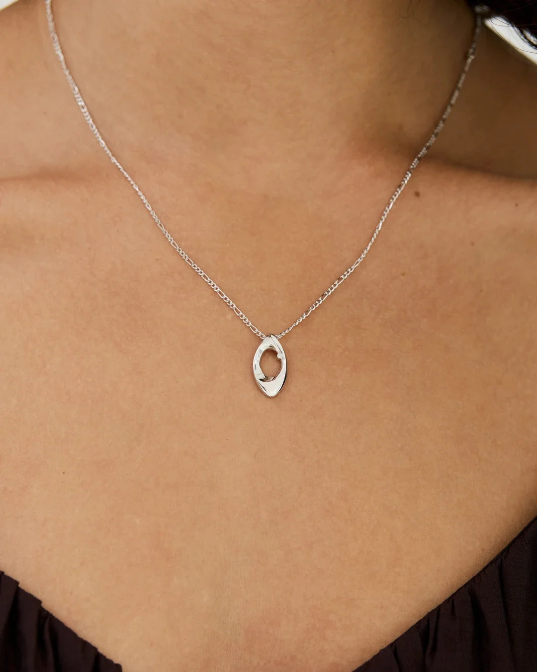 O ओ Initial Necklace in polished silver-toned metal, with a fine chain and an open oval letter pendant.